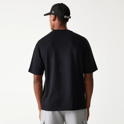 The Male model is wearing Las Vegas Raiders NFL Helmet Black Oversized T-Shirt 2