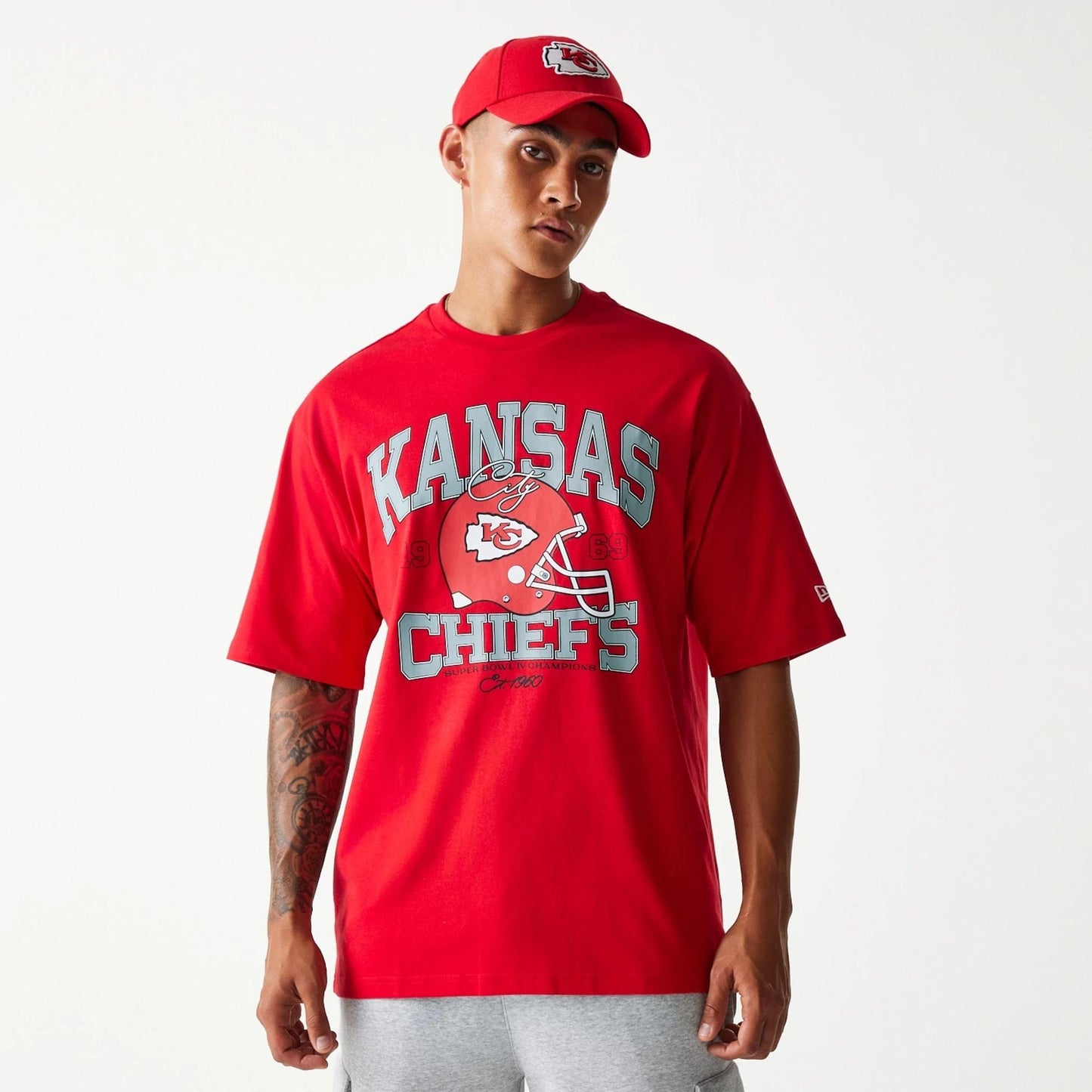 The Male model is wearing Kansas City Chiefs NFL Helmet Red Oversized T-Shirt 1