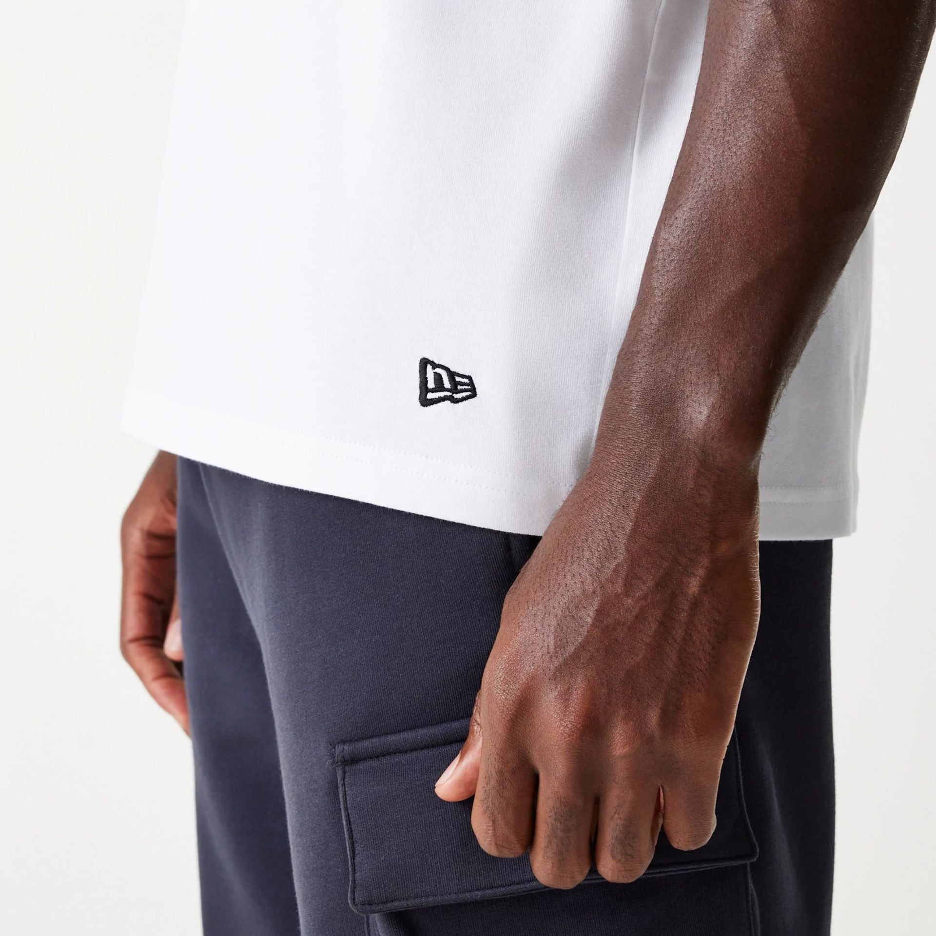 The Male model is wearing New Era Outdoor Graphic White Sleeveless T-Shirt 4