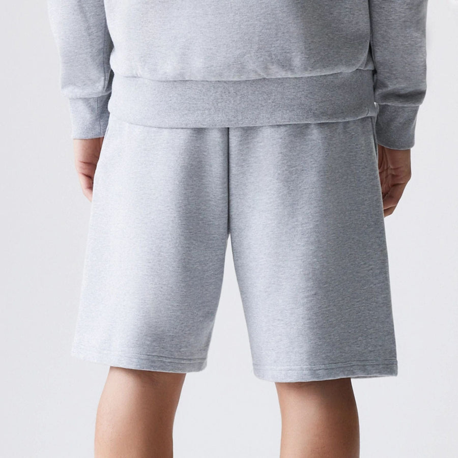 The Male model is wearing New Era Grey Oversized One Panel Shorts 7