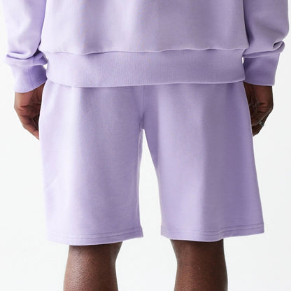 The Male model is wearing New Era Pastel Purple Oversized One Panel Shorts 6