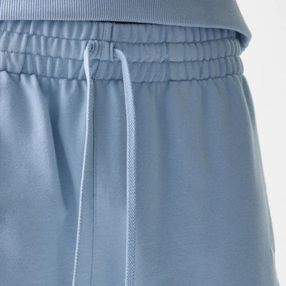 The Male model is wearing New Era Pastel Blue Oversized One Panel Shorts 4