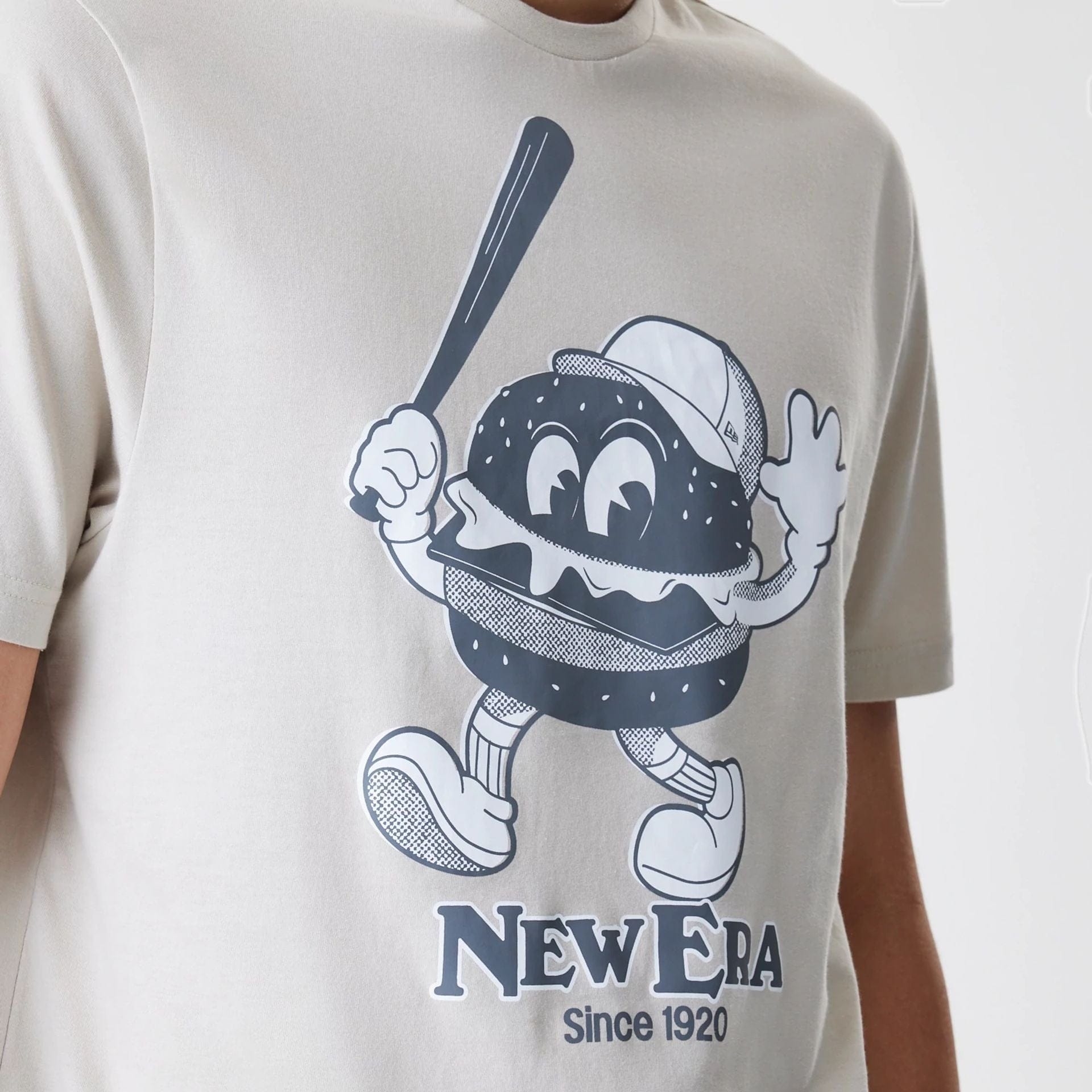 The Male model is wearing New Era Burger Graphic Cream T-Shirt 3