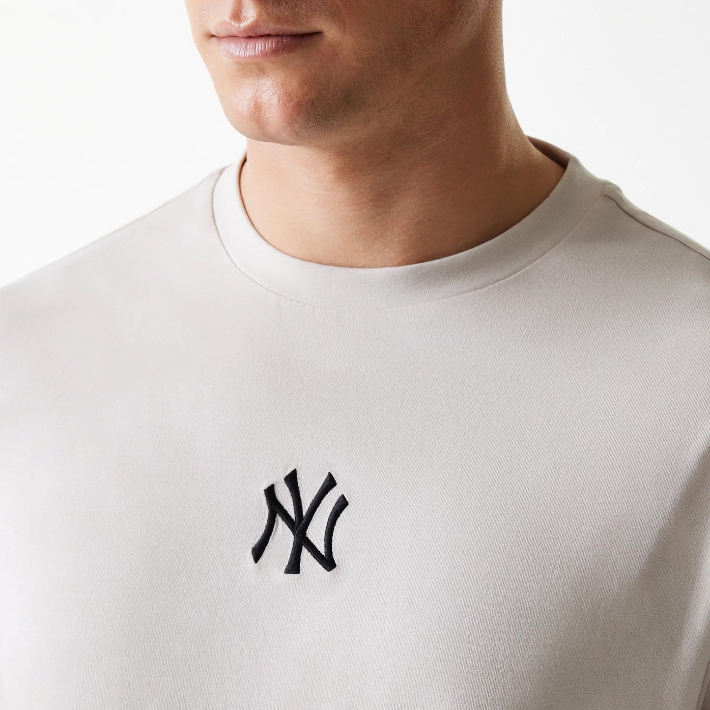 The Male model is wearing New York Yankees MLB League Essential Cream Oversized T-Shirt 4
