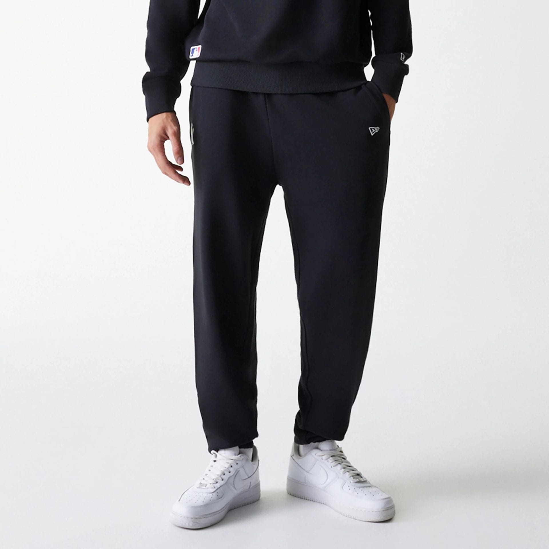 The Male model is wearing New York Yankees MLB League Essential Midi Black Joggers 3