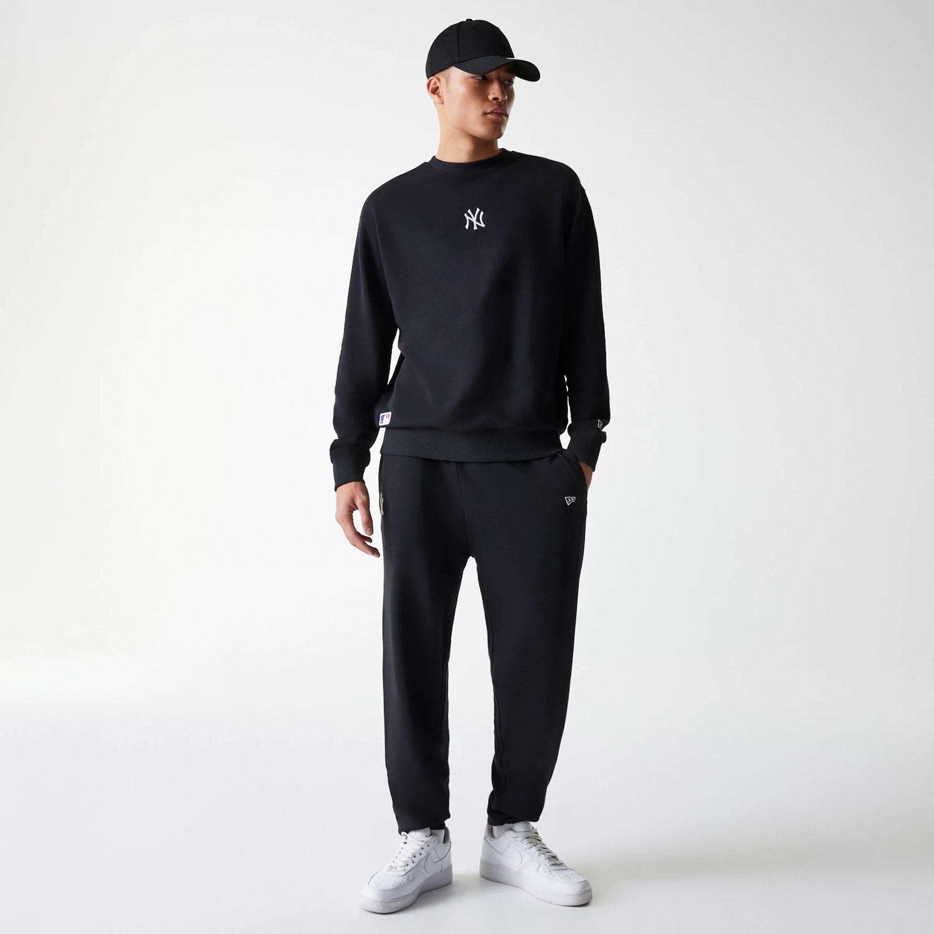 The Male model is wearing New York Yankees MLB League Essential Midi Black Joggers 8