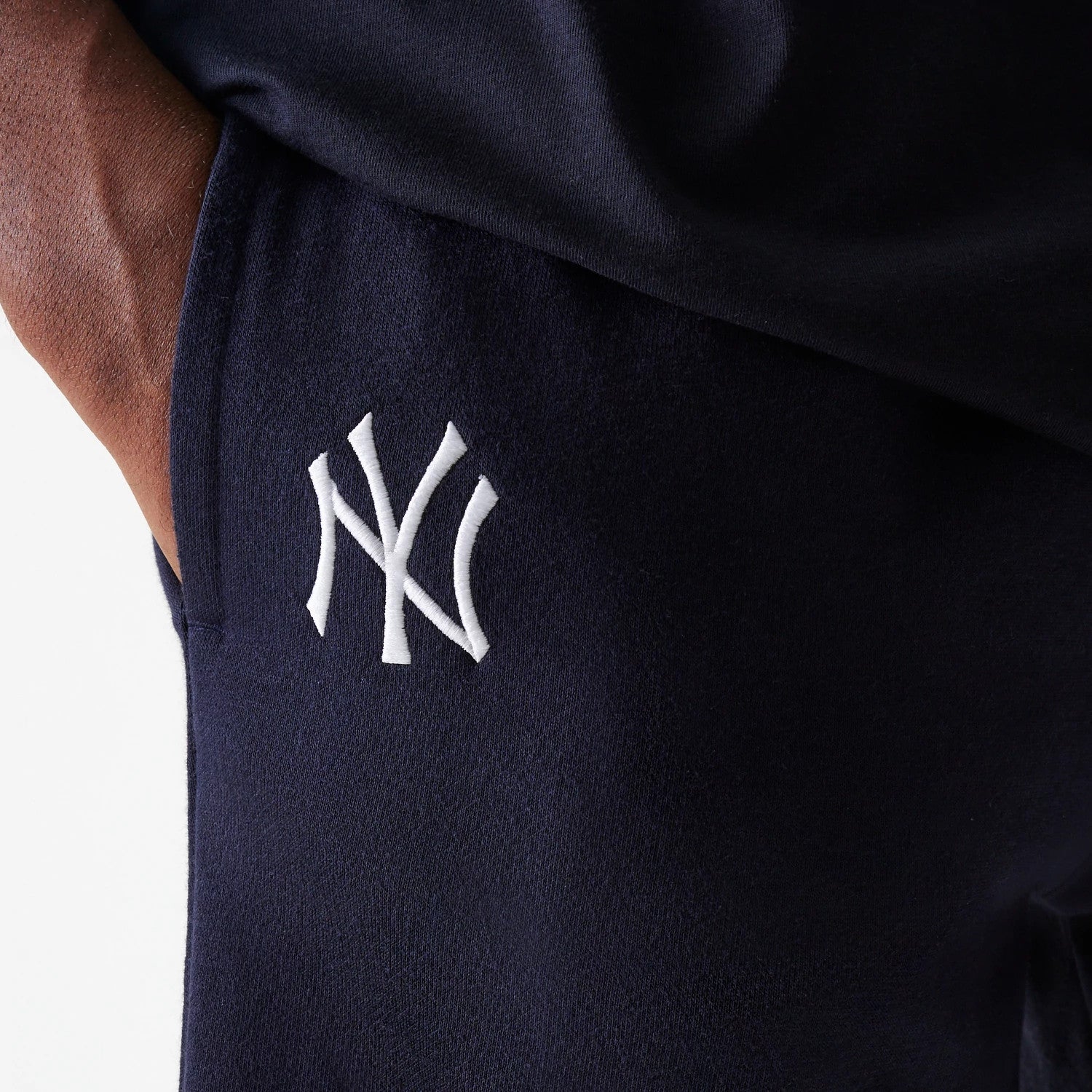 The Male model is wearing New York Yankees MLB League Essential Navy Shorts 4