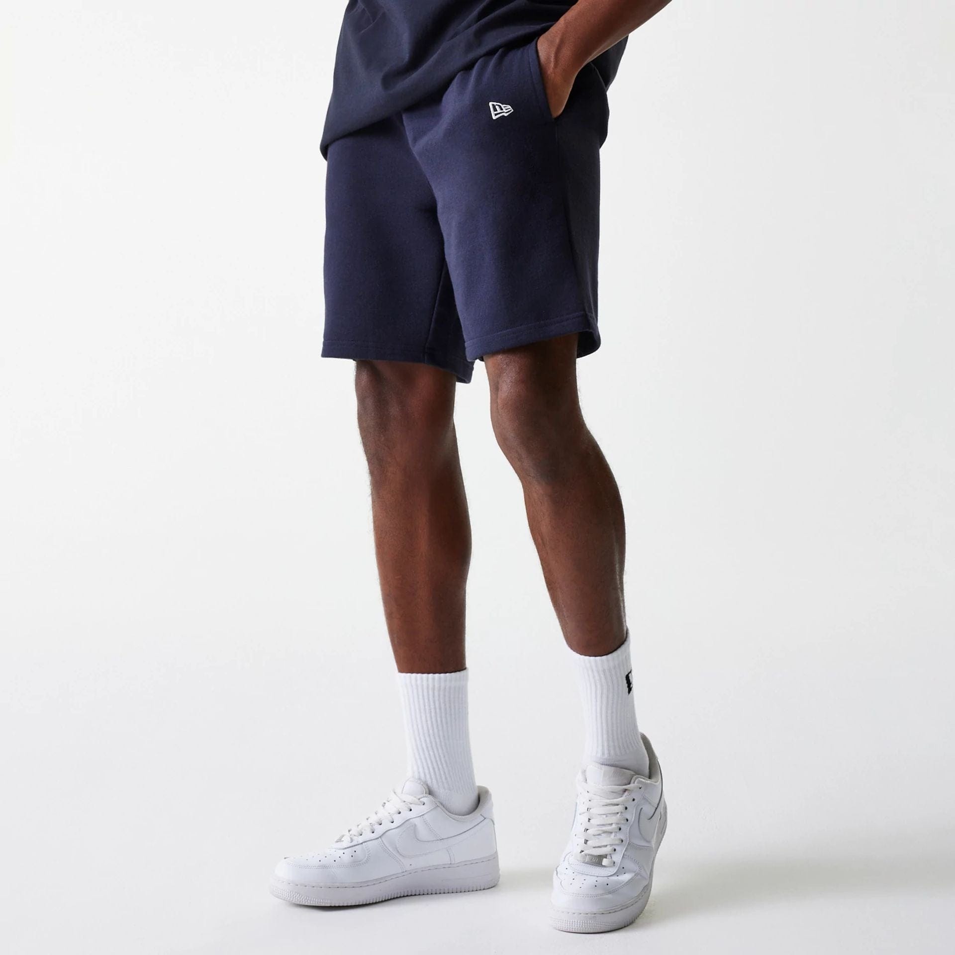 The Male model is wearing New York Yankees MLB League Essential Navy Shorts 1