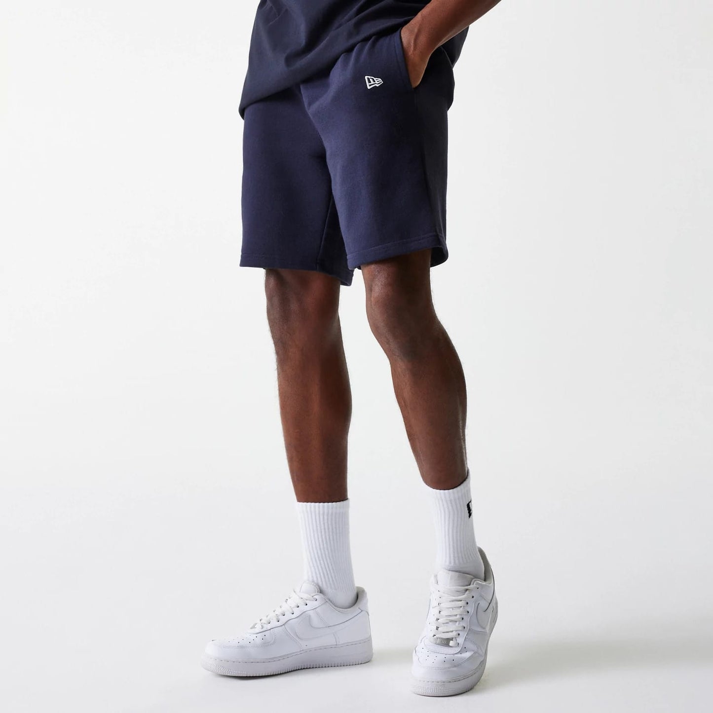 The Male model is wearing New York Yankees MLB League Essential Navy Shorts 1