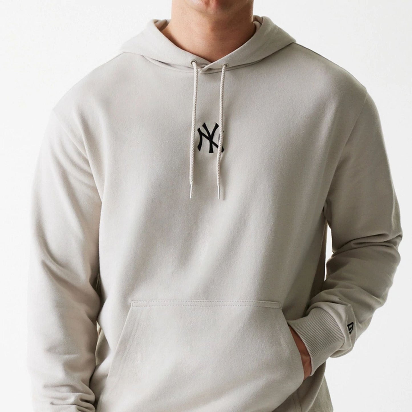 The Male model is wearing New York Yankees MLB League Essential Midi Cream Oversized Pullover Hoodie 3