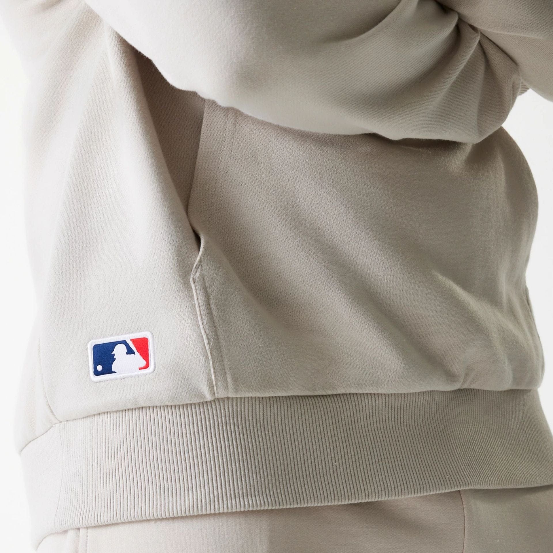 The Male model is wearing New York Yankees MLB League Essential Midi Cream Oversized Pullover Hoodie 6