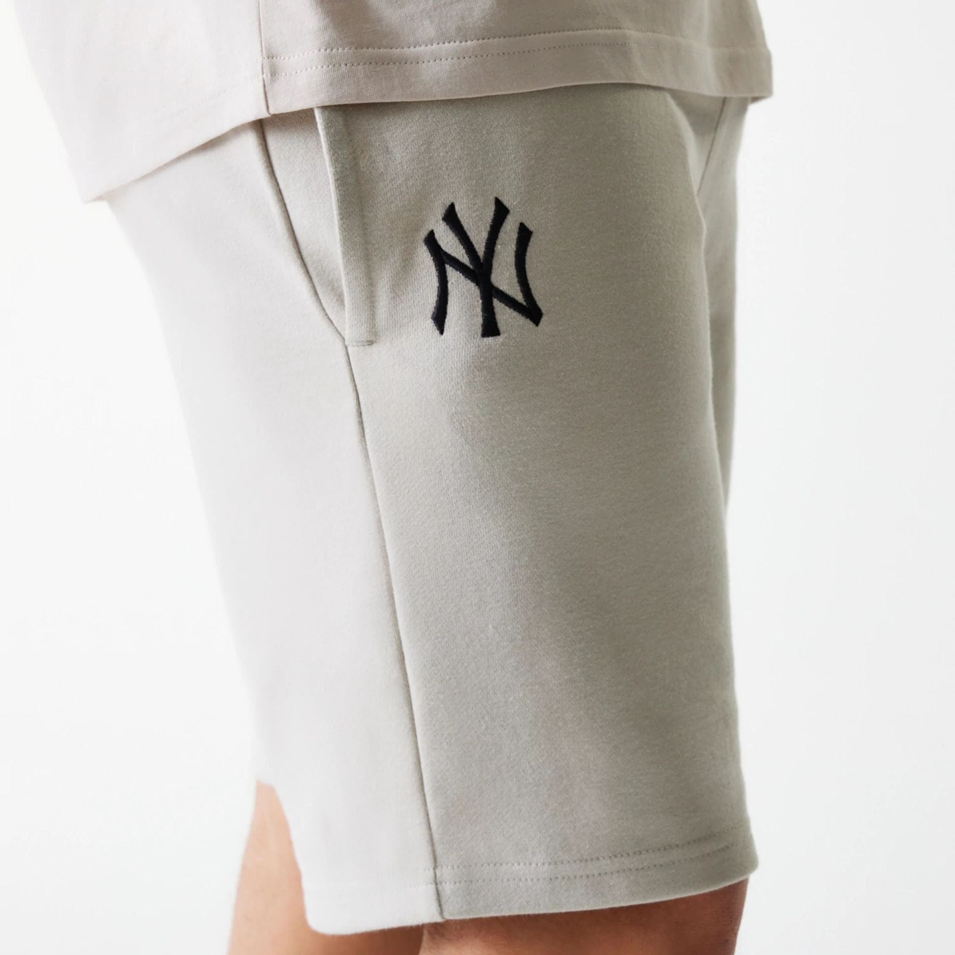The Male model is wearing New York Yankees MLB League Essential Cream Shorts 5