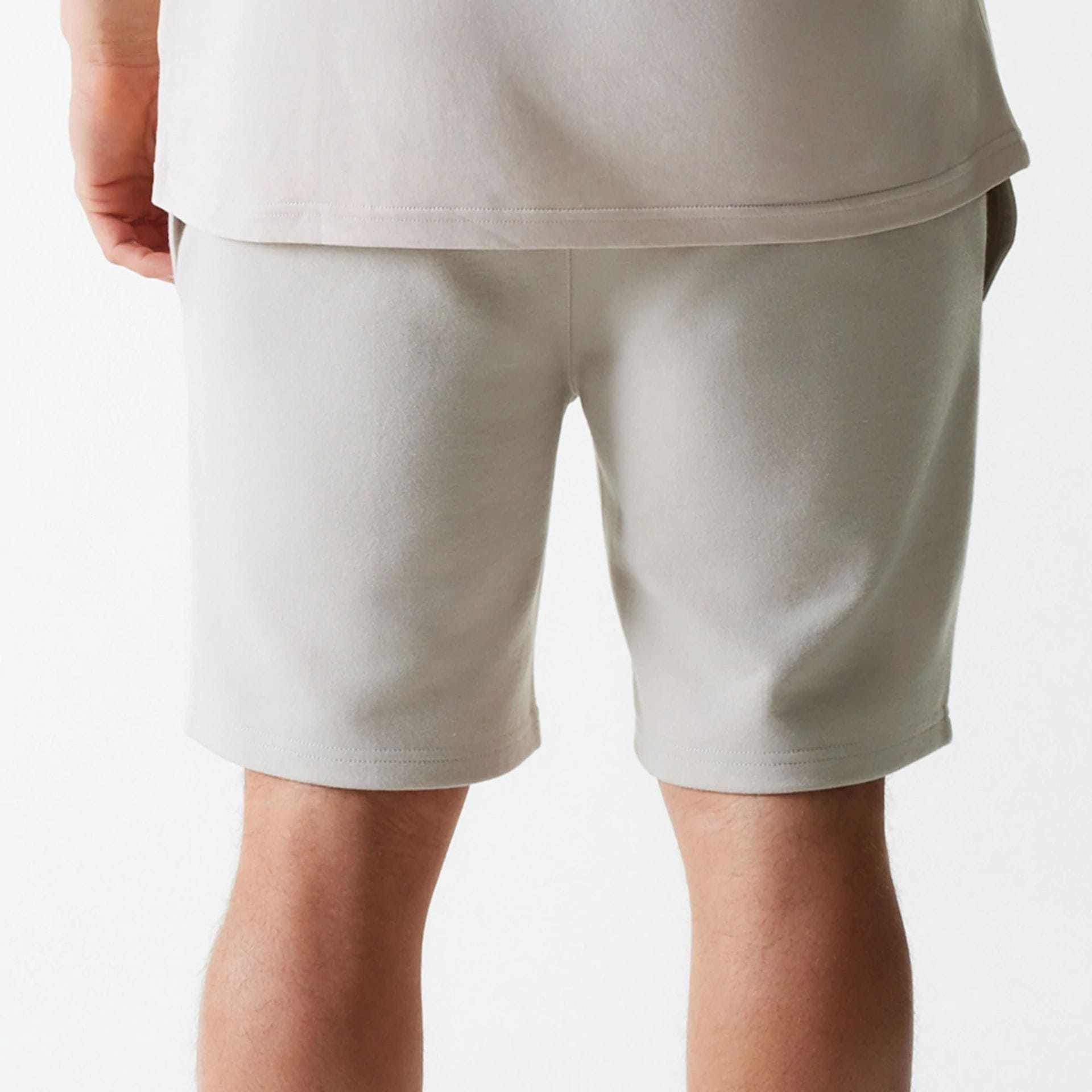 The Male model is wearing New York Yankees MLB League Essential Cream Shorts 6