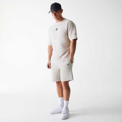 The Male model is wearing New York Yankees MLB League Essential Cream Shorts 8