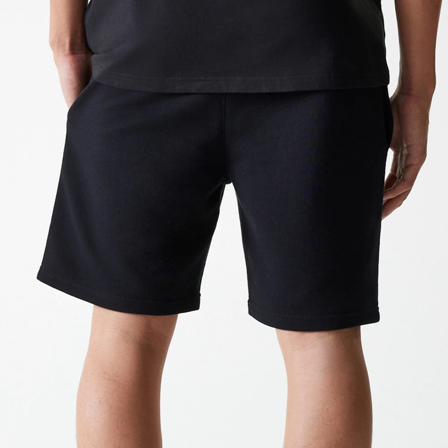 The Male model is wearing New York Yankees MLB League Essential Black Shorts 7