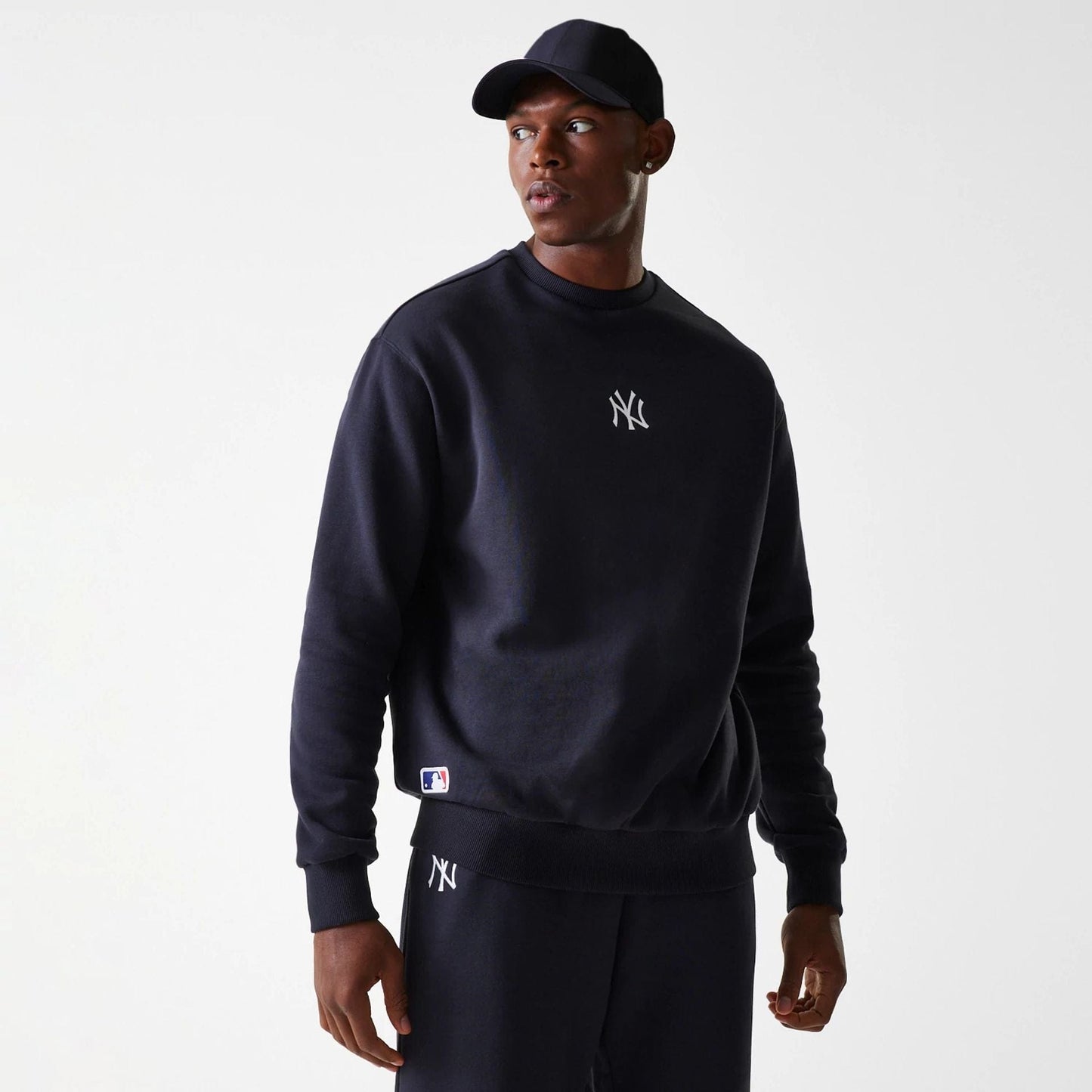 The Male model is wearing New York Yankees MLB League Essential Navy Crew Neck Sweater 1