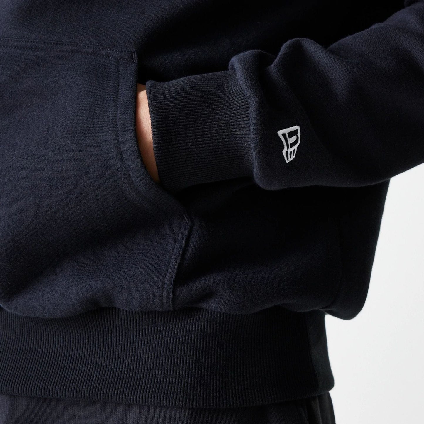 The Male model is wearing New York Yankees MLB League Essential Midi Black Oversized Pullover Hoodie 5