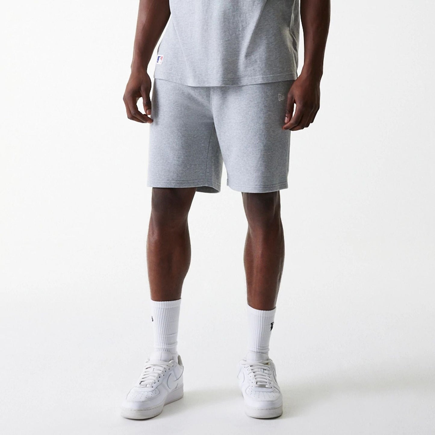 The Male model is wearing New York Yankees MLB League Essential Grey Shorts 3
