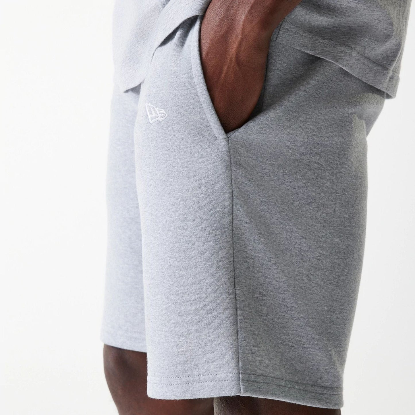 The Male model is wearing New York Yankees MLB League Essential Grey Shorts 5