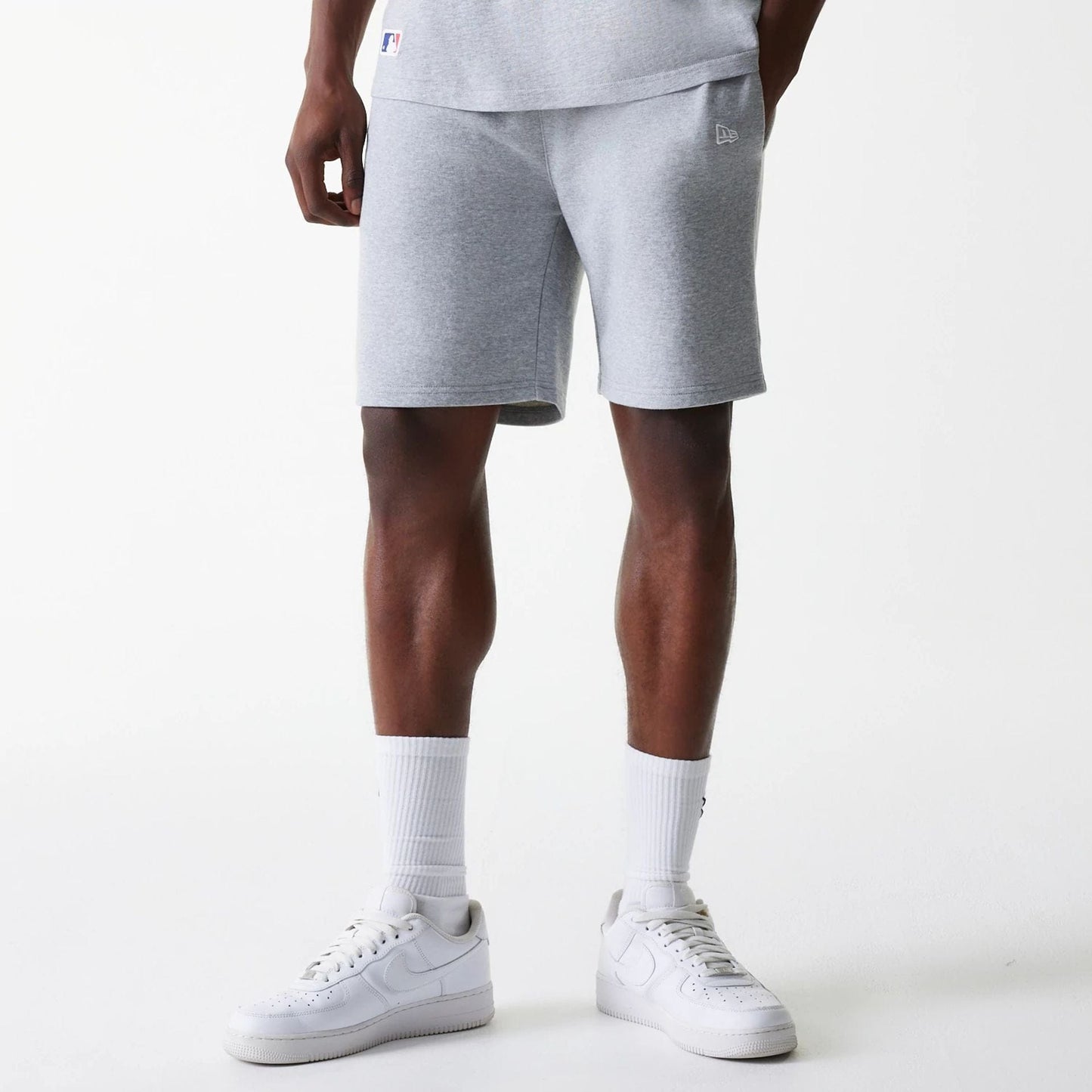 The Male model is wearing New York Yankees MLB League Essential Grey Shorts 1