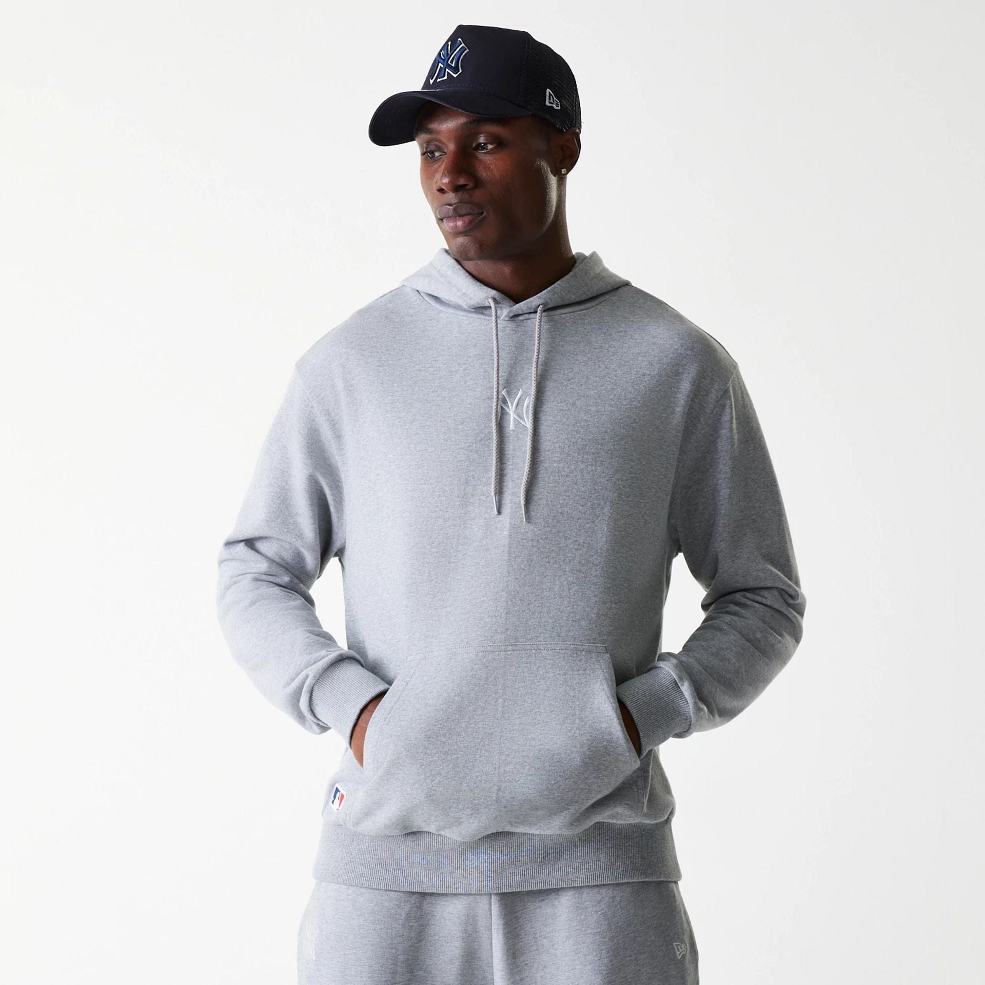 The Male model is wearing New York Yankees MLB League Essential Midi Grey Oversized Pullover Hoodie 1