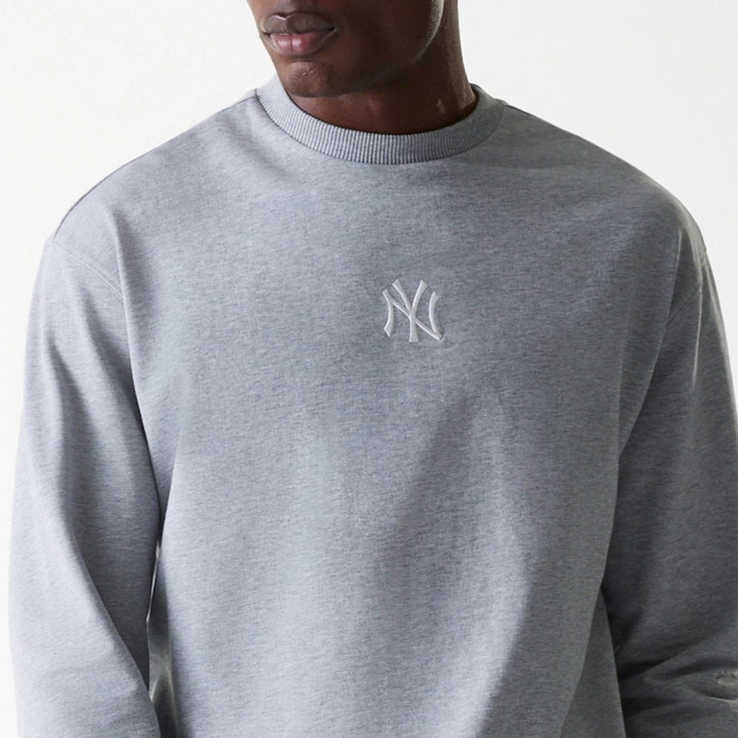The Male model is wearing New York Yankees MLB League Essential Grey Crew Neck Sweater. 6