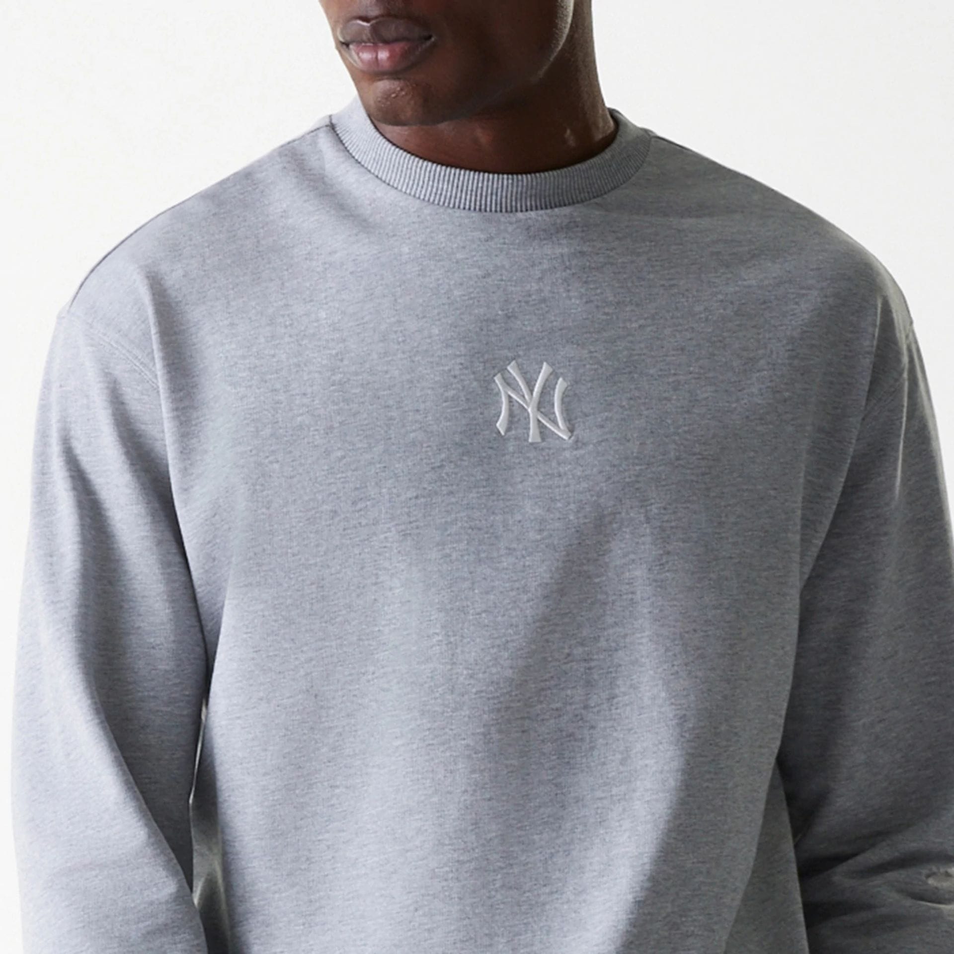 The Male model is wearing New York Yankees MLB League Essential Grey Crew Neck Sweater. 6