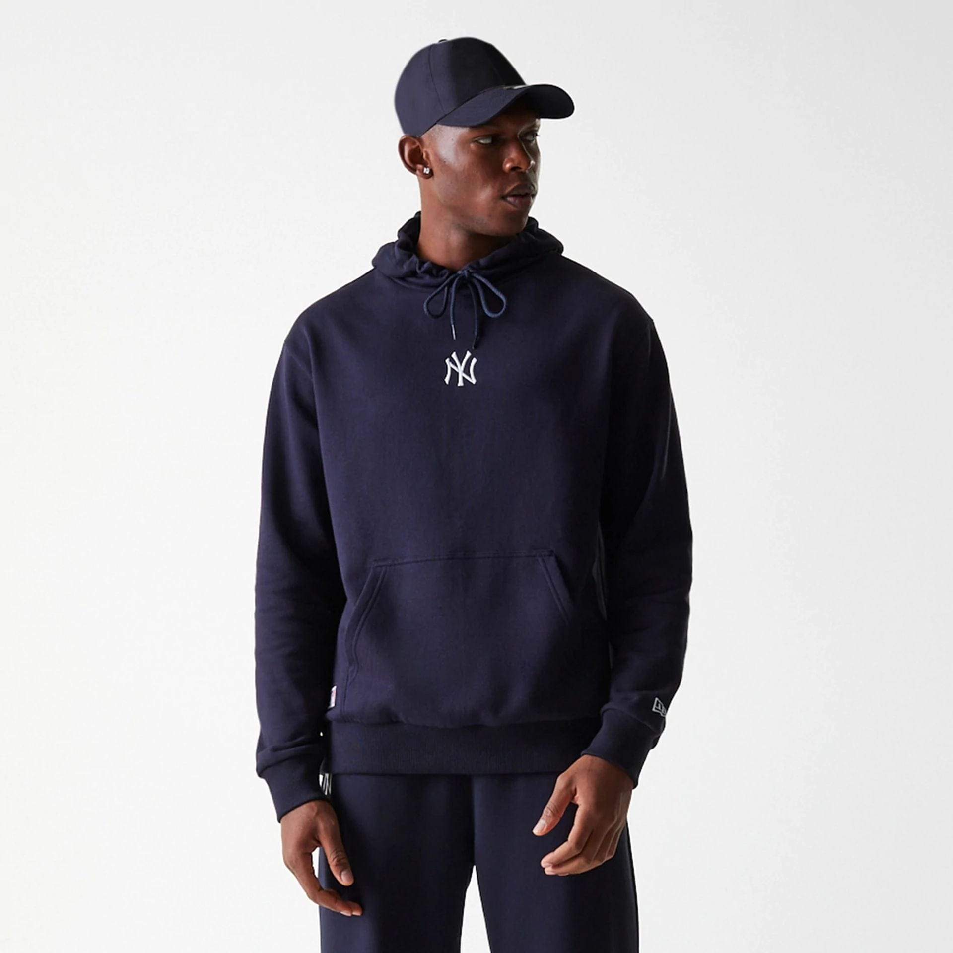 The Male model is wearing New York Yankees MLB League Essential Midi Navy Oversized Pullover Hoodie 3