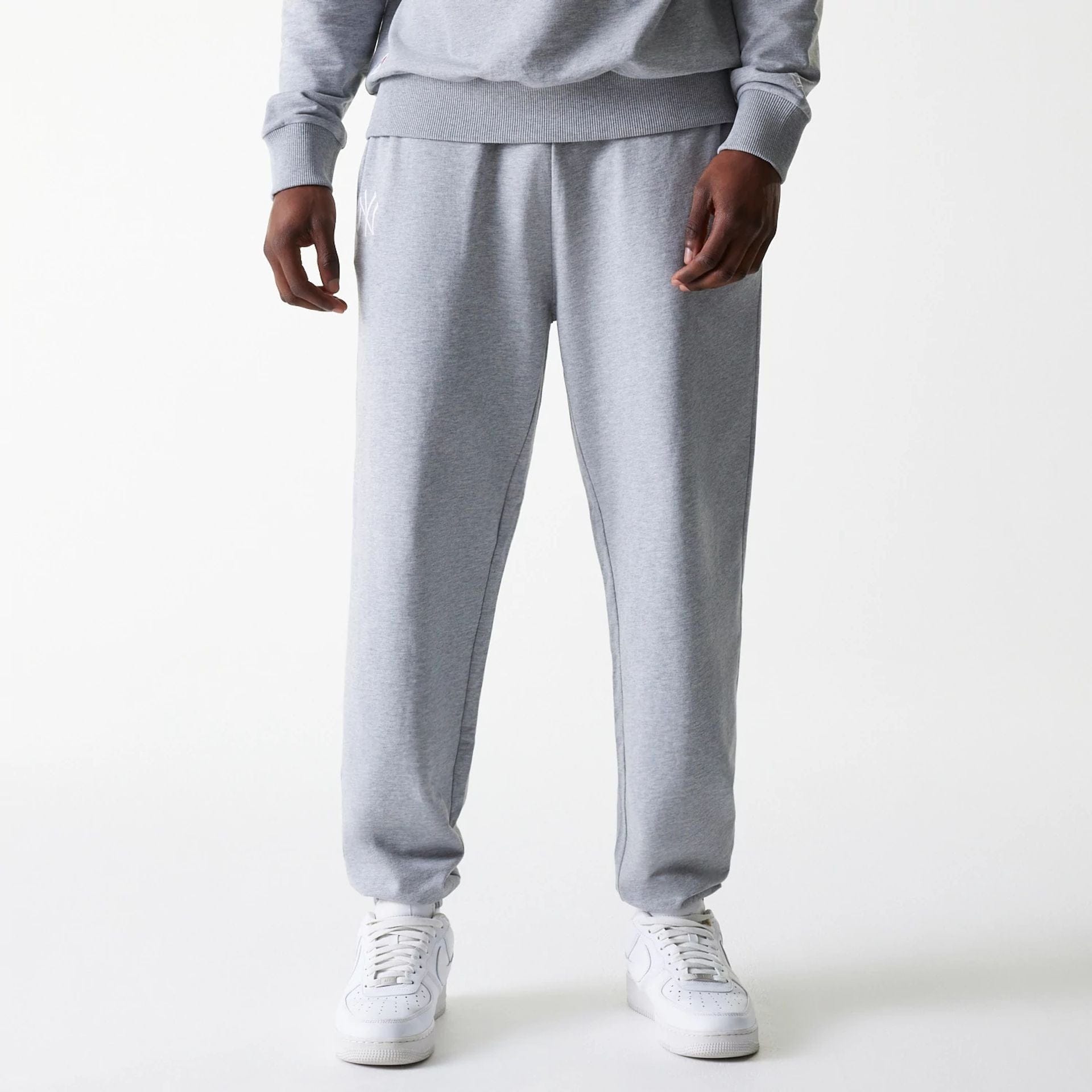 The Male model is wearing New York Yankees MLB League Essential Midi Grey Joggers 1
