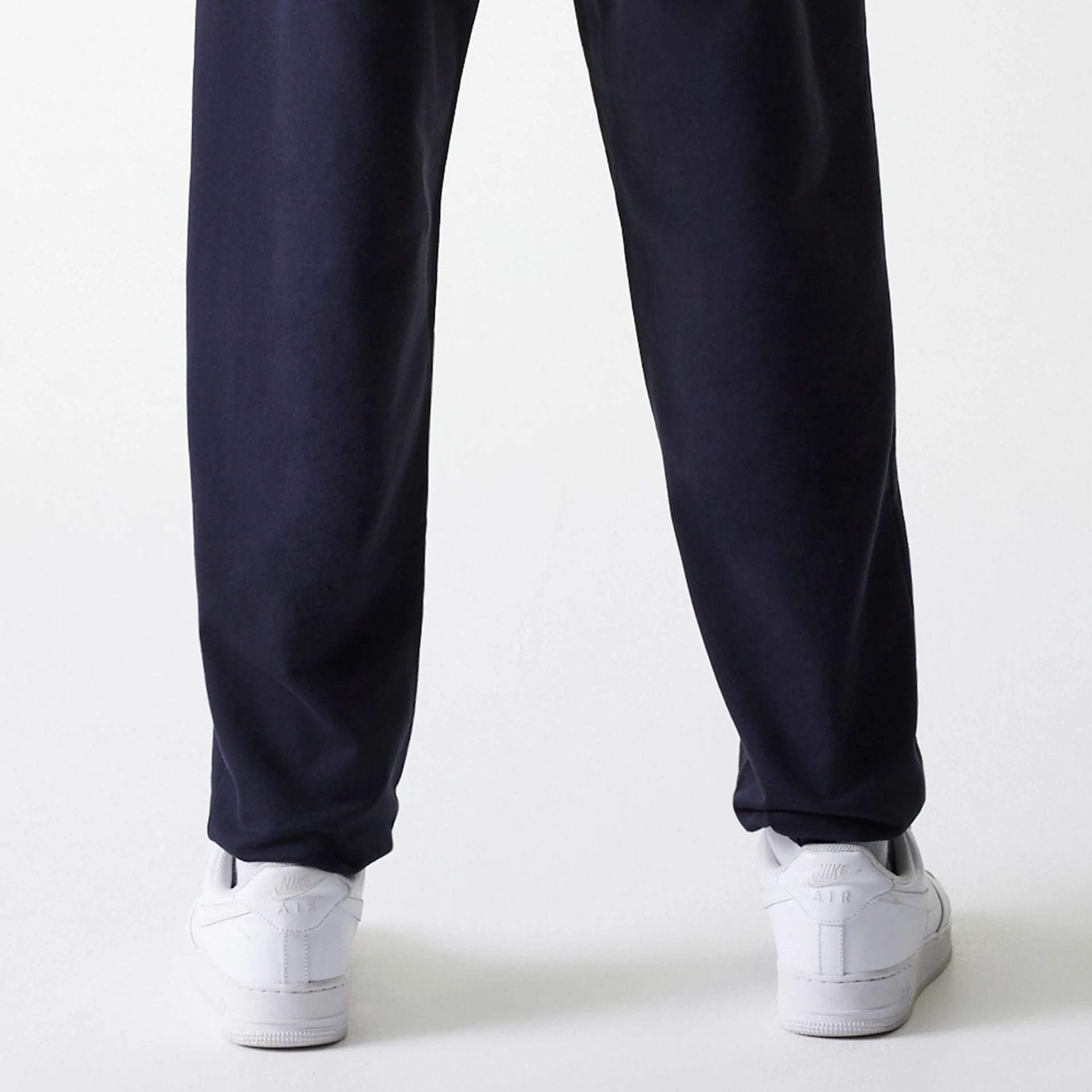 The Male model is wearing New York Yankees MLB League Essential Midi Navy Joggers 7