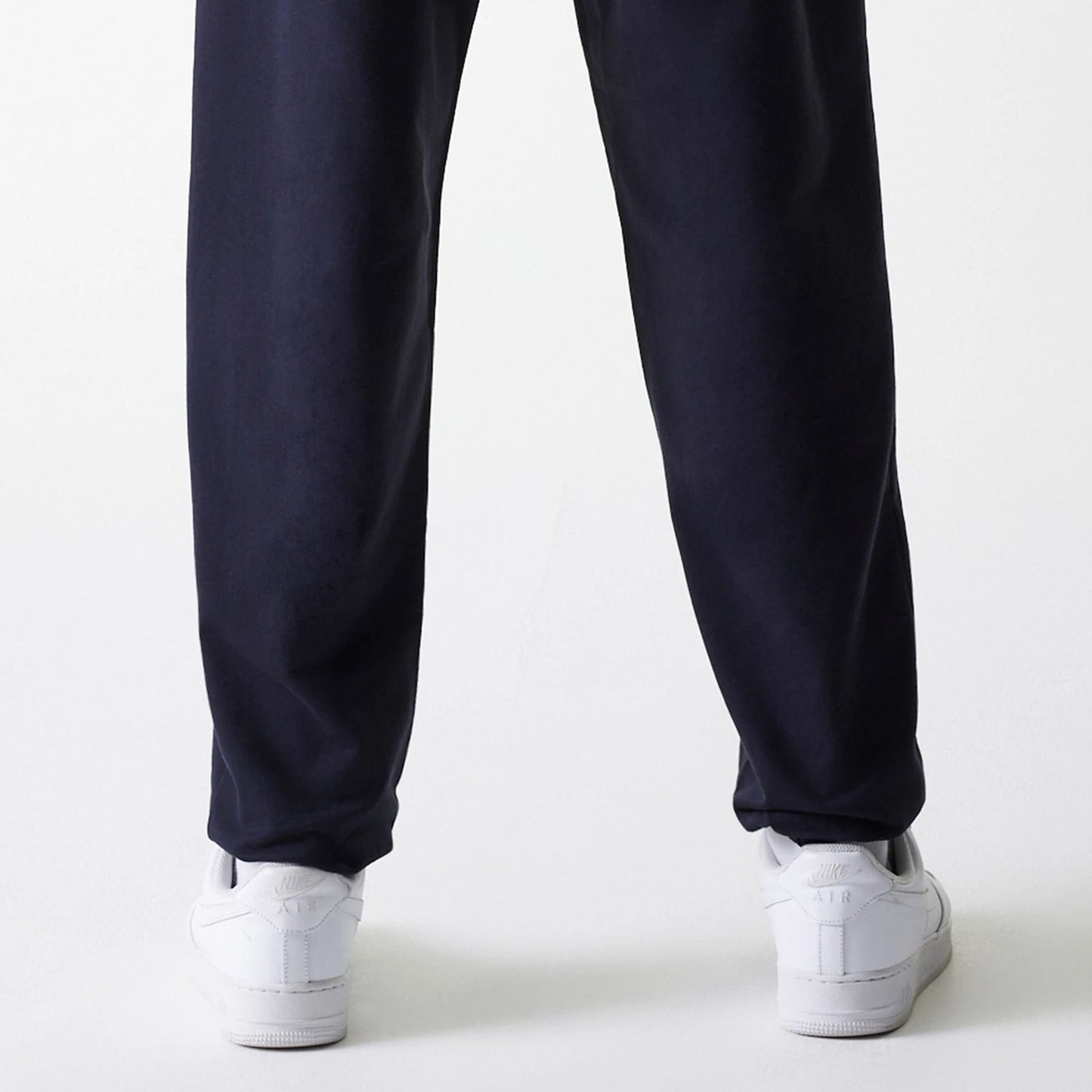 The Male model is wearing New York Yankees MLB League Essential Midi Navy Joggers 7