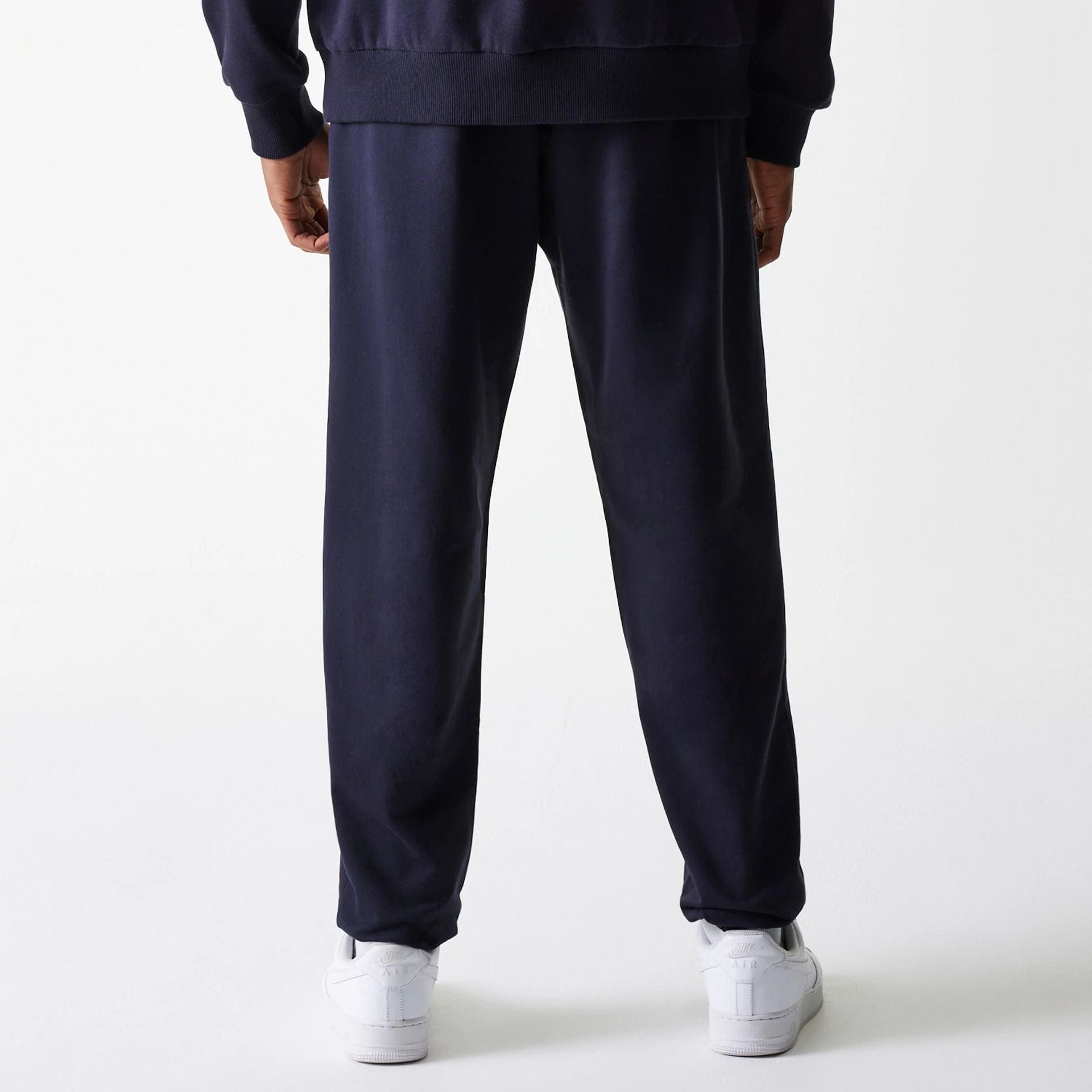 The Male model is wearing New York Yankees MLB League Essential Midi Navy Joggers 2