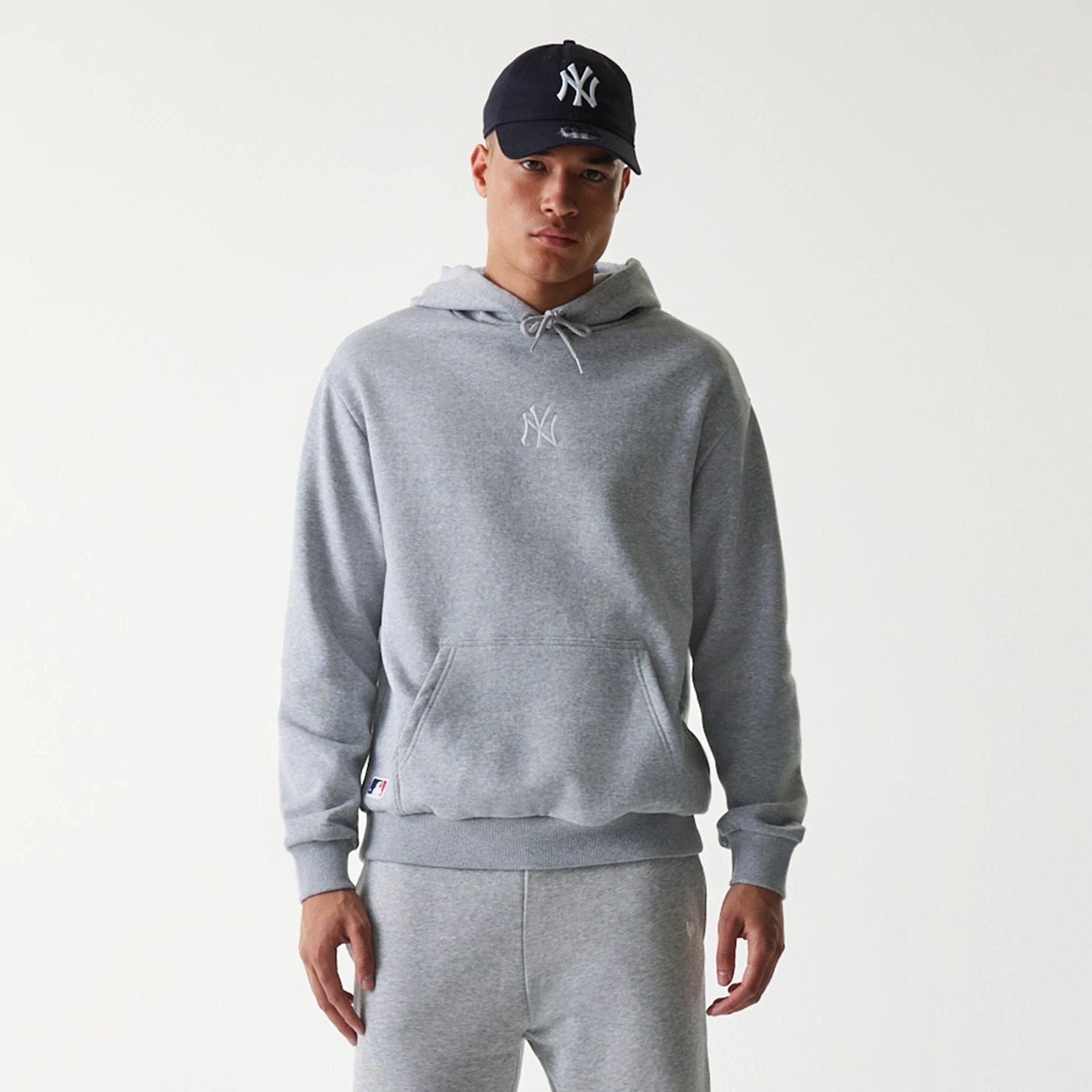 The Male model is wearing New York Yankees MLB League Essential Grey Oversized Pullover Hoodie 3