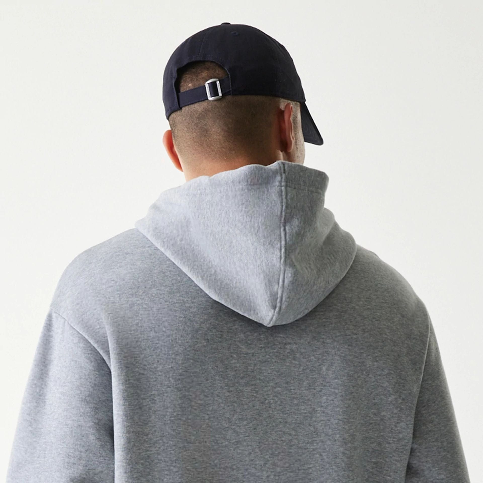 The Male model is wearing New York Yankees MLB League Essential Grey Oversized Pullover Hoodie 6