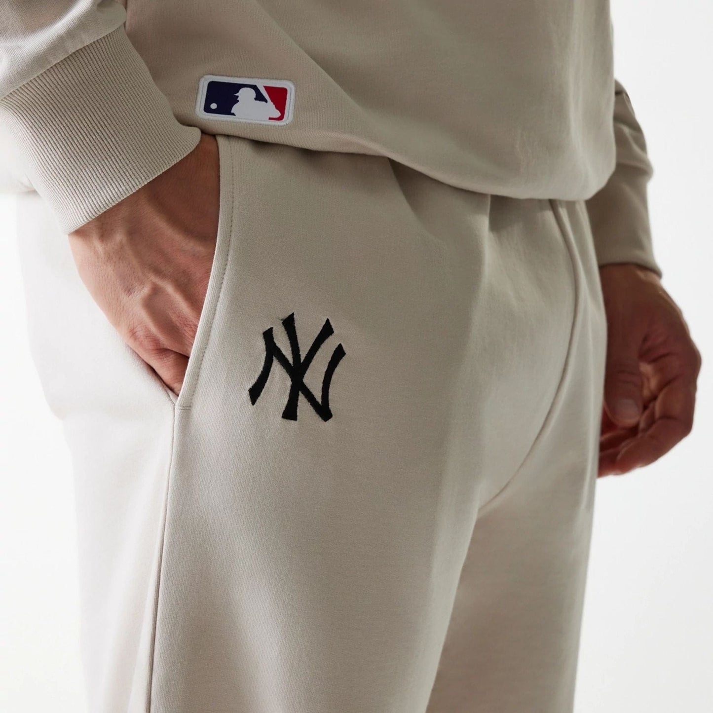 The Male model is wearing New York Yankees MLB League Essential Midi Cream Joggers 4