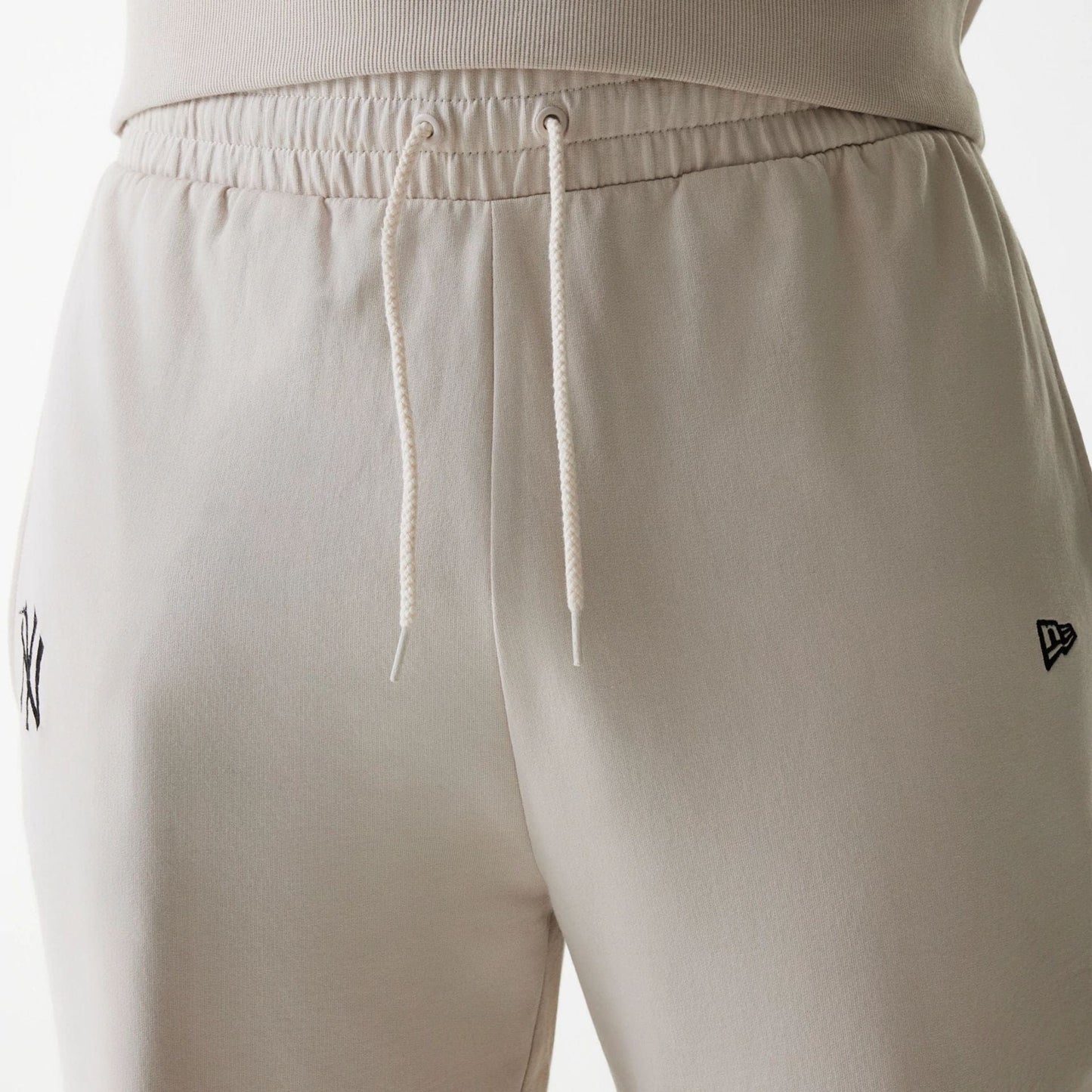 The Male model is wearing New York Yankees MLB League Essential Midi Cream Joggers 6