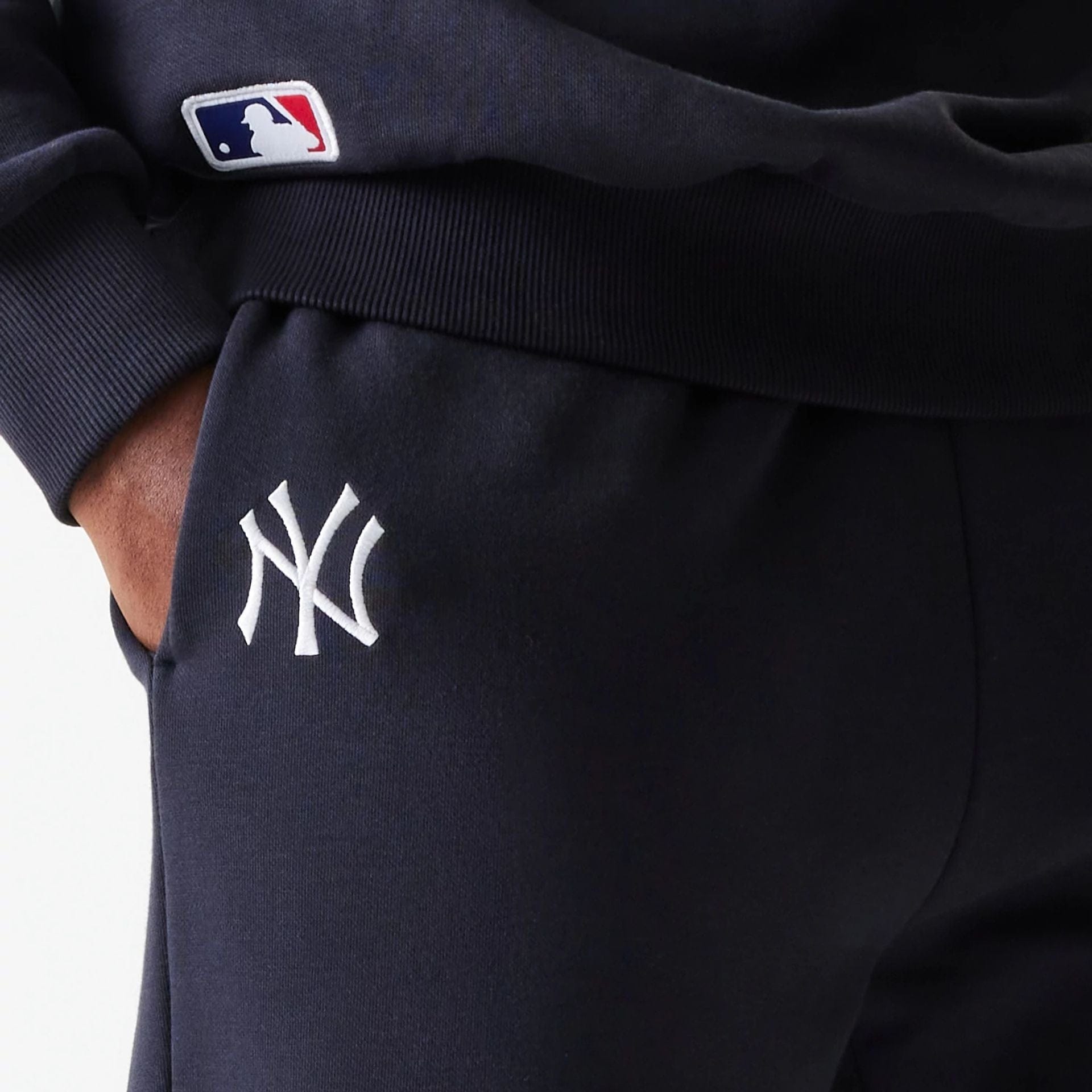 The Male model is wearing New York Yankees MLB League Essential Navy Joggers 4