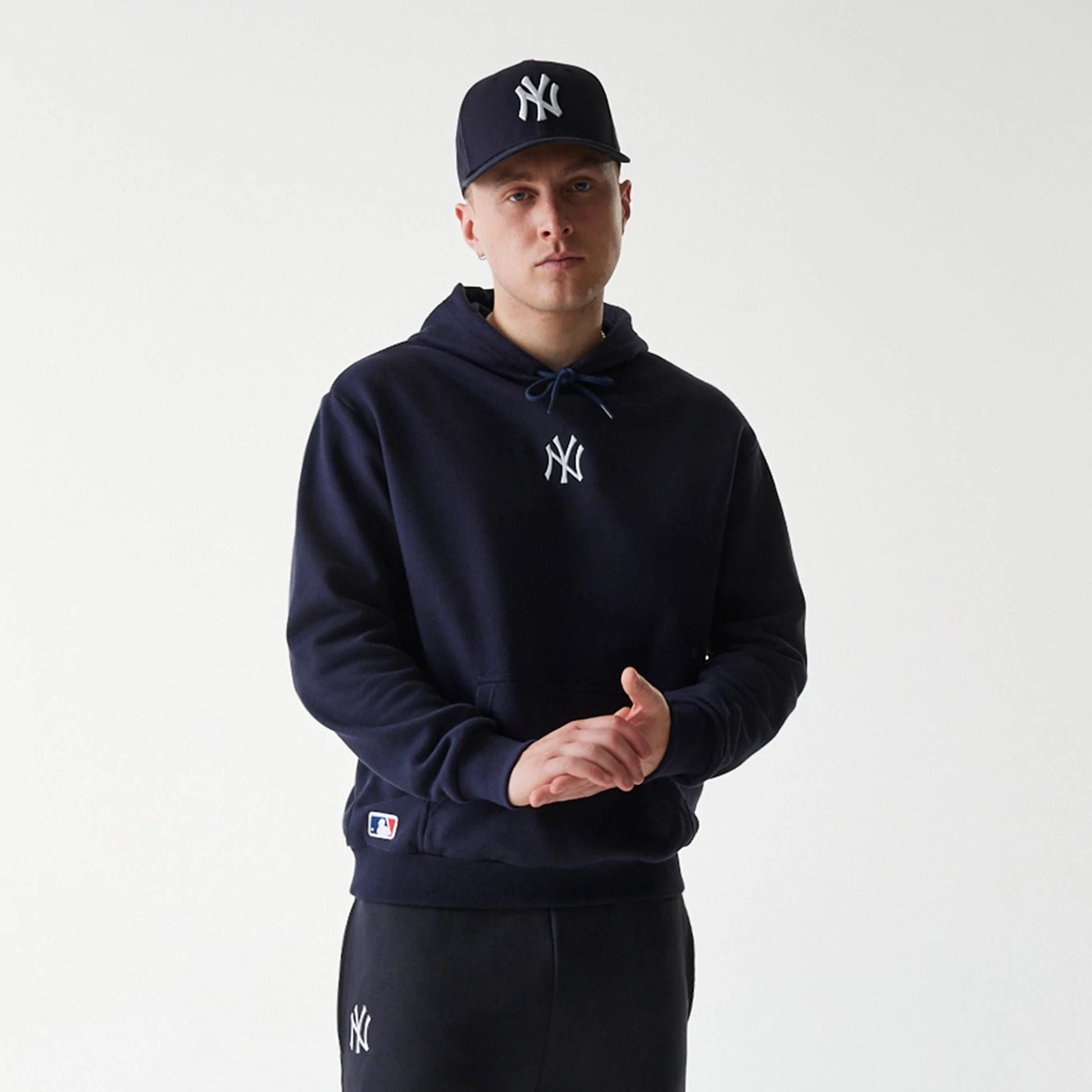 The Male model is wearing New York Yankees MLB League Essential Navy Oversized Pullover Hoodie 3
