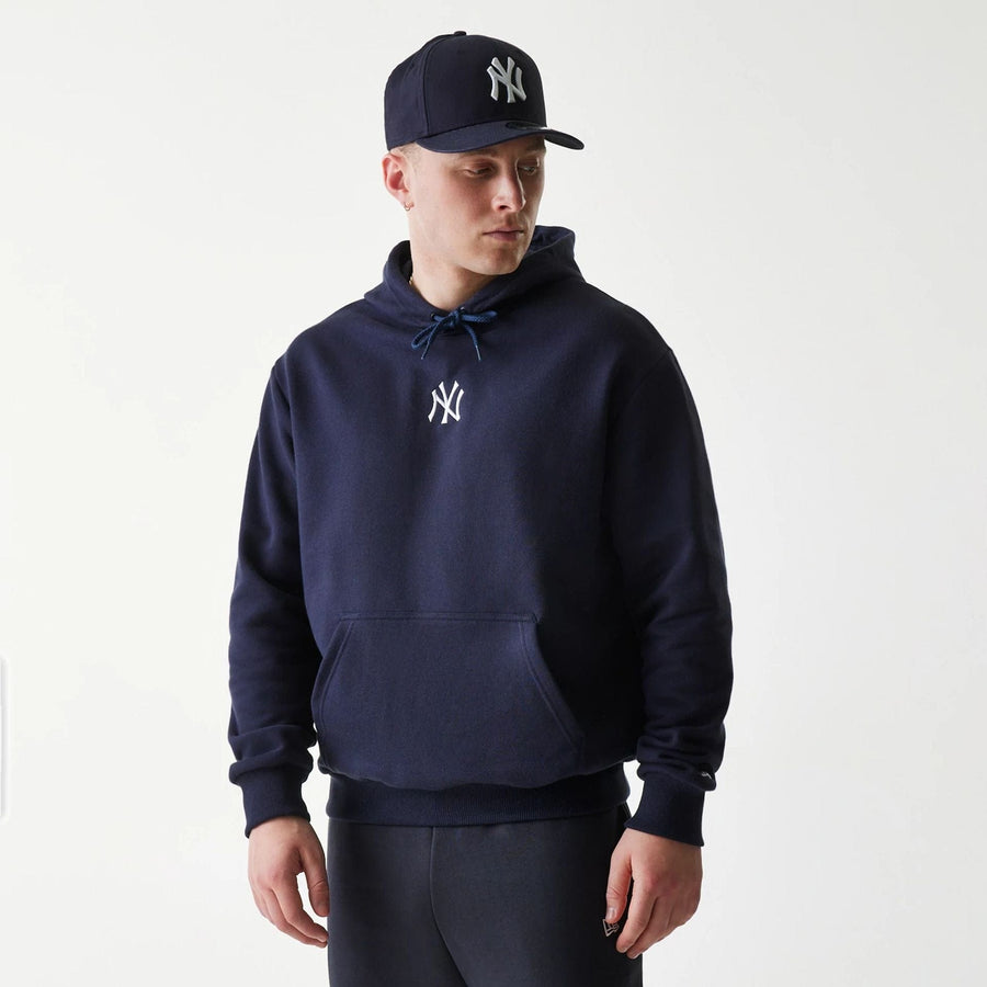 The Male model is wearing New York Yankees MLB League Essential Navy Oversized Pullover Hoodie 1