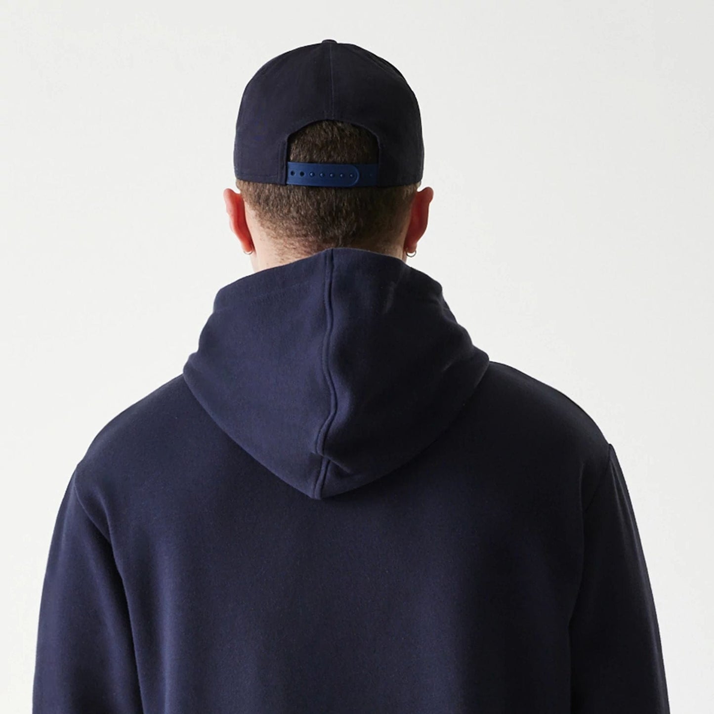 The Male model is wearing New York Yankees MLB League Essential Navy Oversized Pullover Hoodie 5
