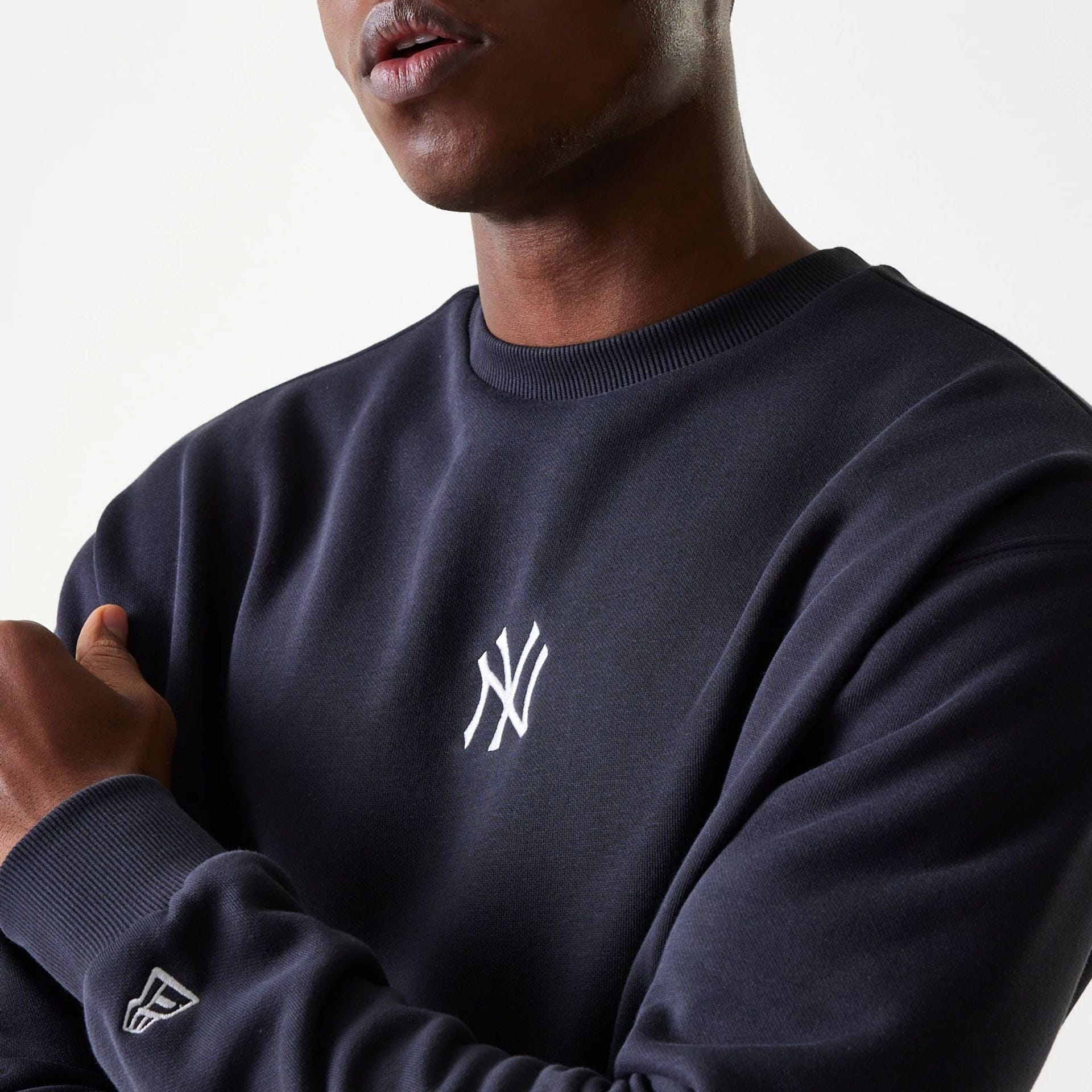 The Male model is wearing New York Yankees MLB League Essential Midi Navy Oversized Crew Neck Sweater 4