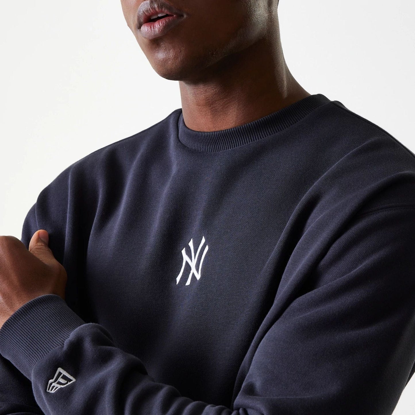 The Male model is wearing New York Yankees MLB League Essential Midi Navy Oversized Crew Neck Sweater 4