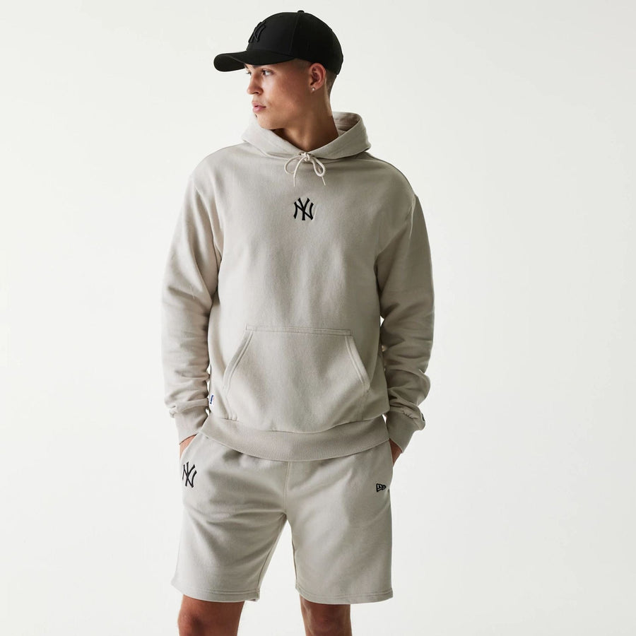 The Male model is wearing New York Yankees MLB League Essential Cream Oversized Pullover Hoodie 1