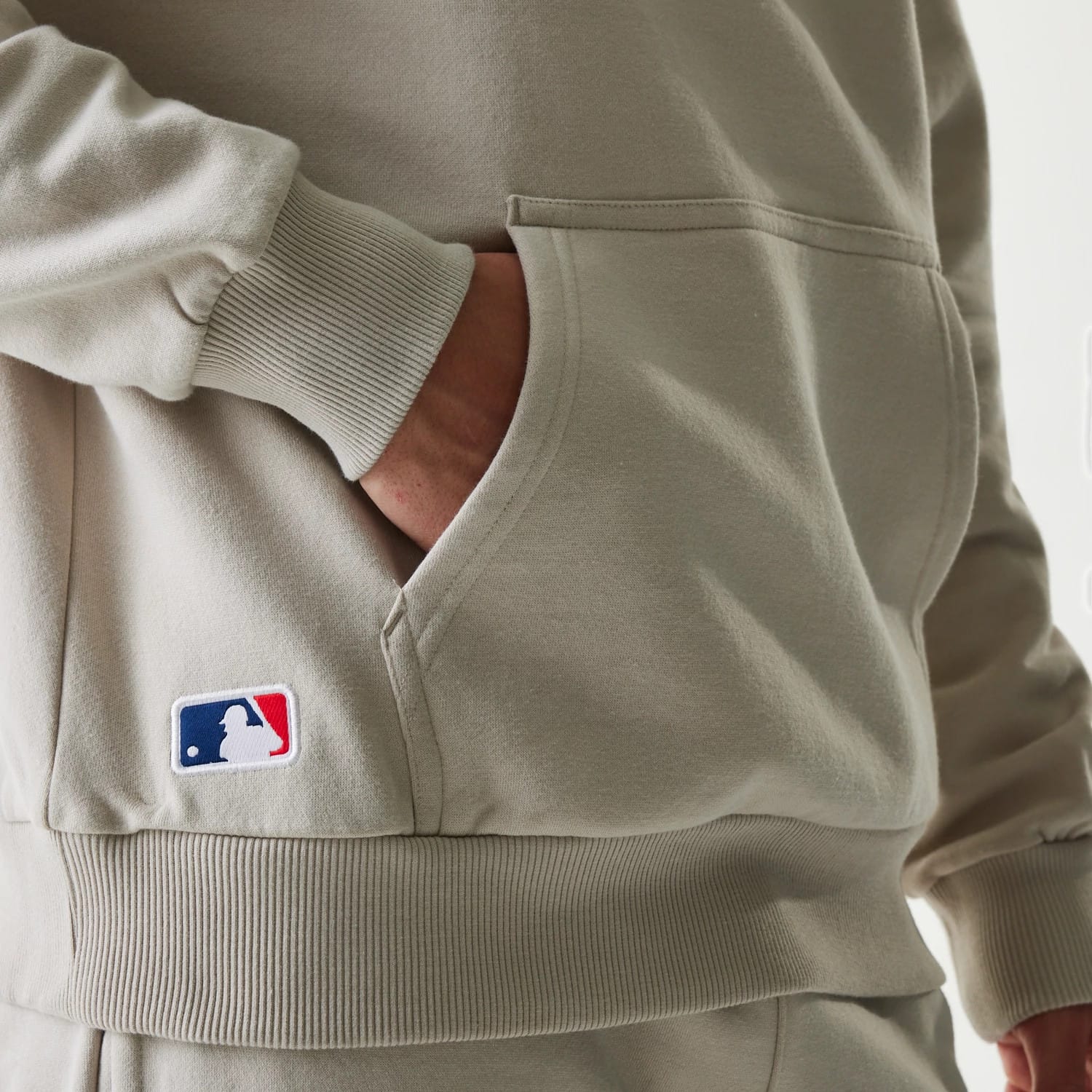The Male model is wearing New York Yankees MLB League Essential Cream Oversized Pullover Hoodie 4
