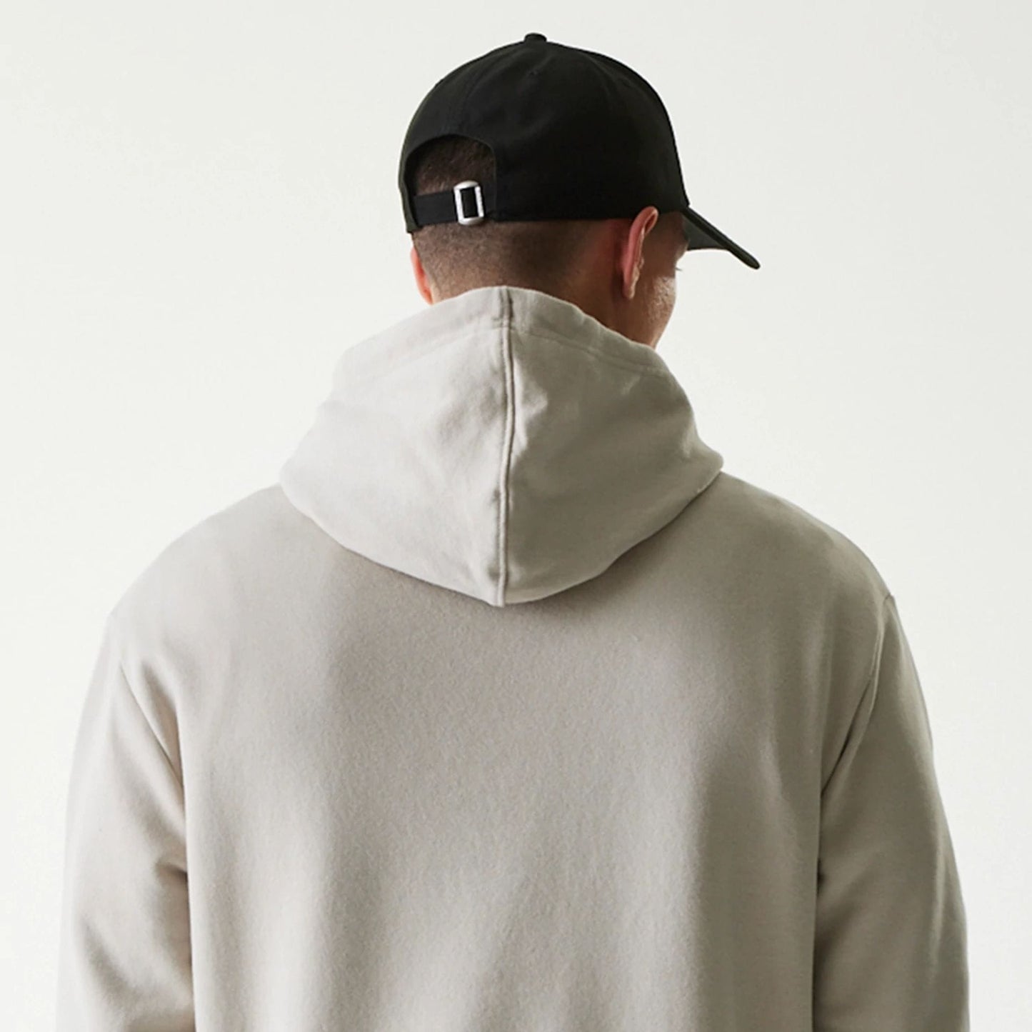 The Male model is wearing New York Yankees MLB League Essential Cream Oversized Pullover Hoodie 7
