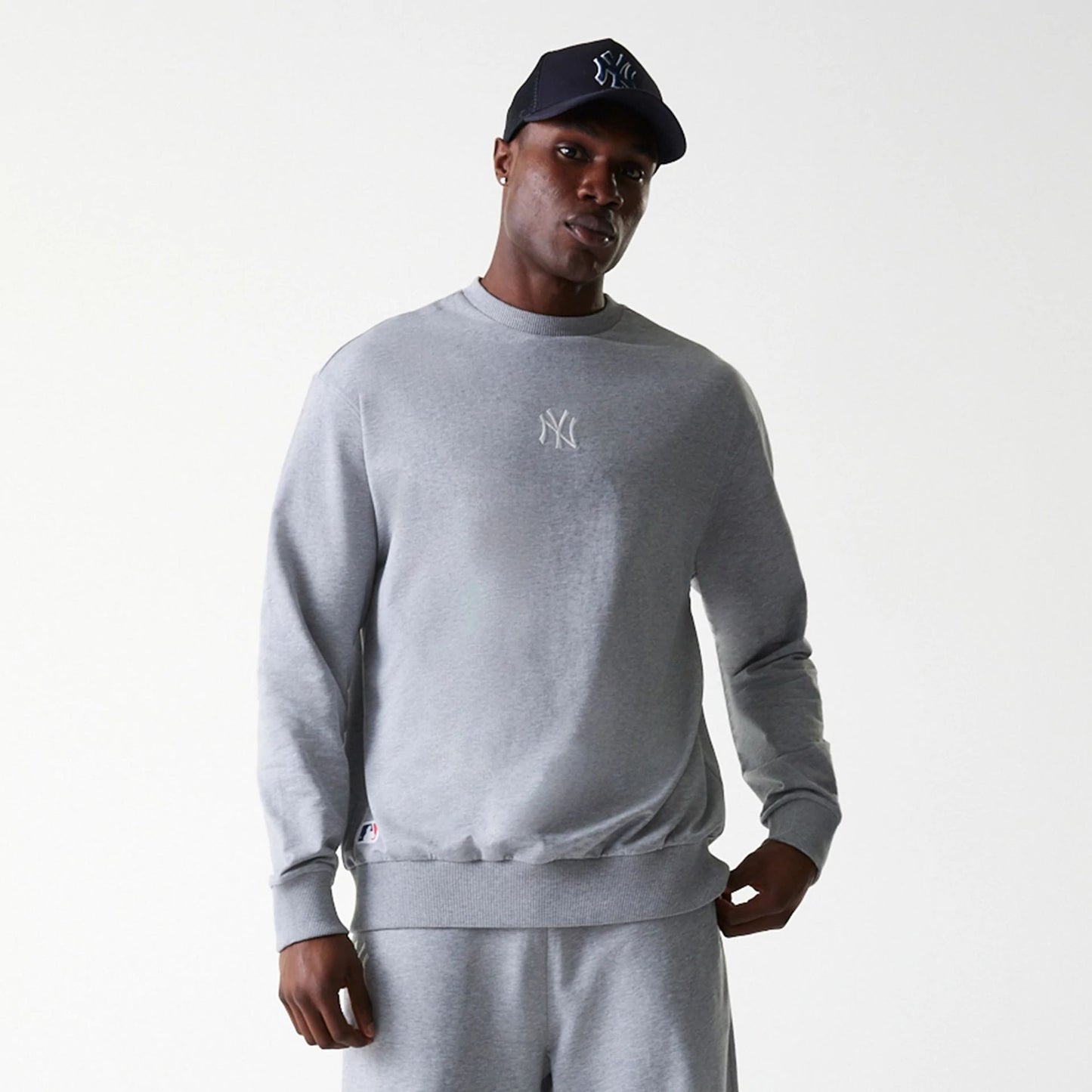 The Male model is wearing New York Yankees MLB League Essential Midi Grey Oversized Crew Neck Sweater 3