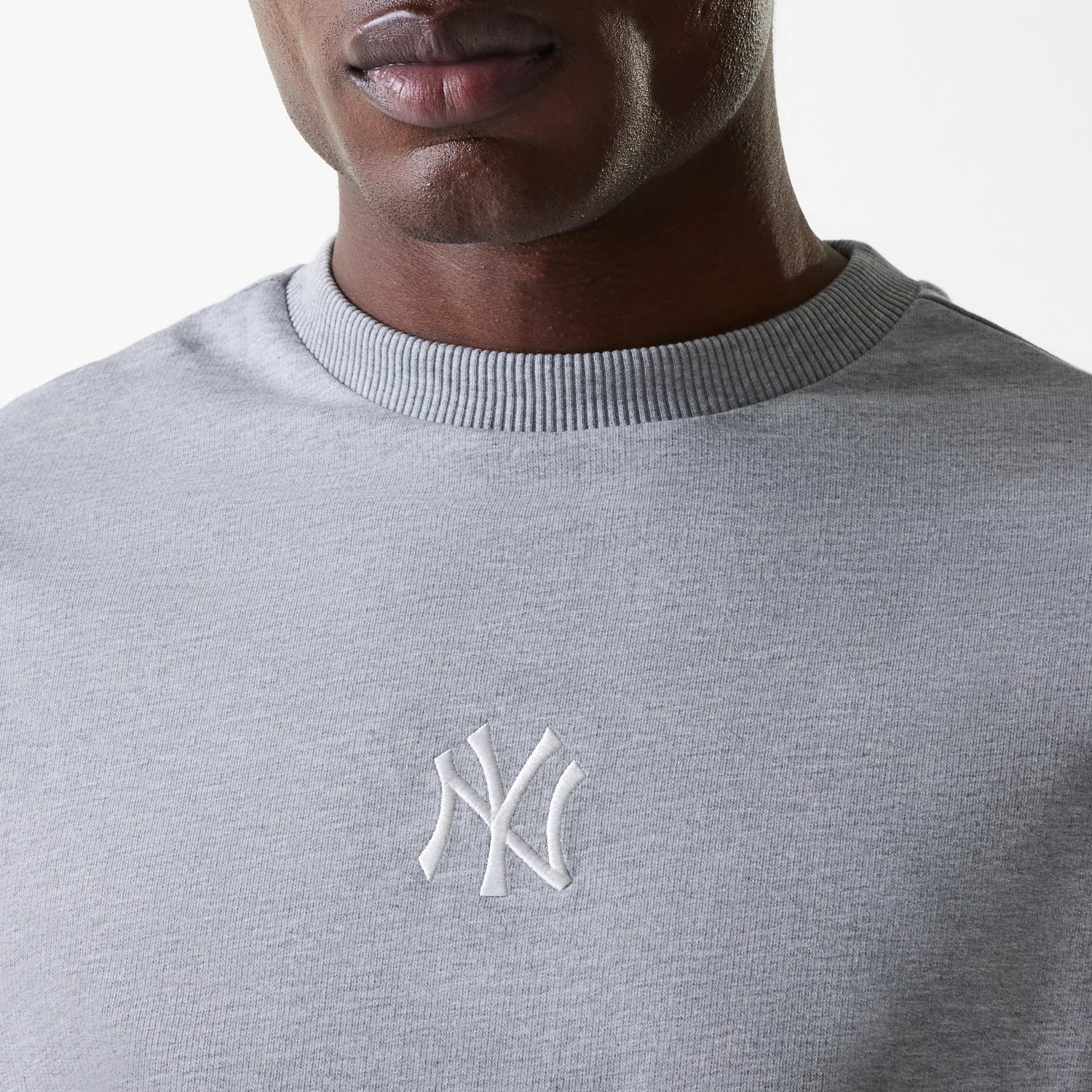 The Male model is wearing New York Yankees MLB League Essential Midi Grey Oversized Crew Neck Sweater 4