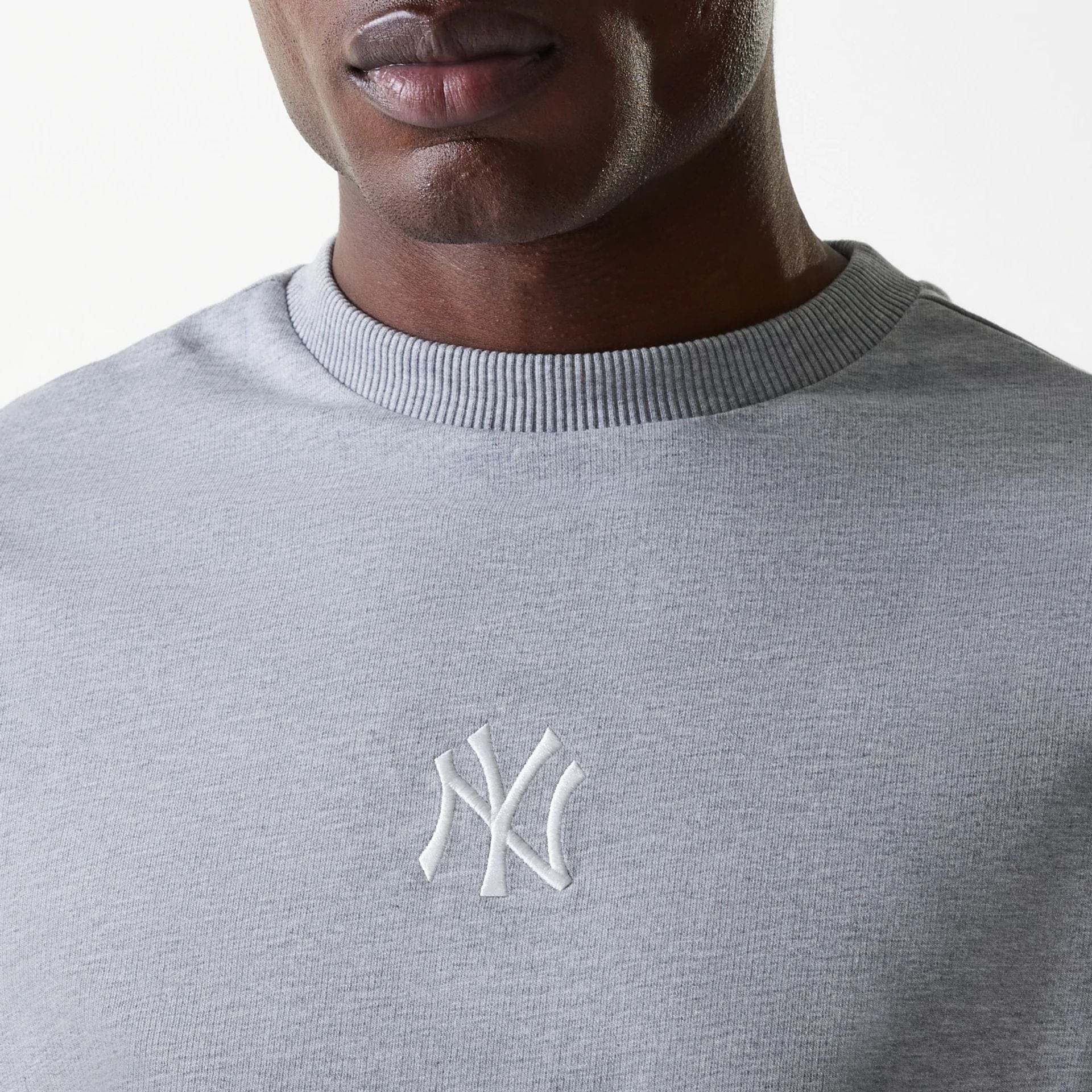 The Male model is wearing New York Yankees MLB League Essential Midi Grey Oversized Crew Neck Sweater 4