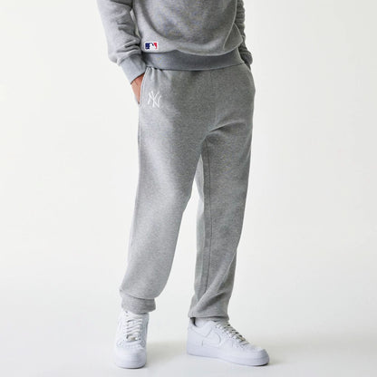 The Male model is wearing New York Yankees MLB League Essential Grey Joggers 1