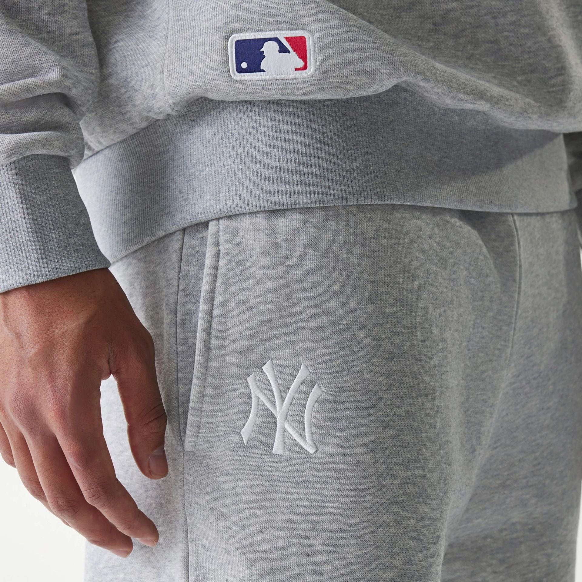 The Male model is wearing New York Yankees MLB League Essential Grey Joggers 5